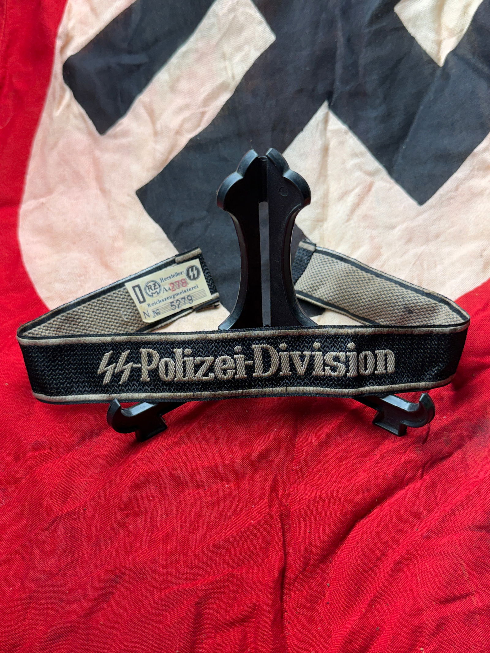 WW2 German SS Police Division Cuff Title (Ärmelstreifen), with RZM Tag: This embroidered cuff title (Ärmelstreifen) was worn on the lower sleeve of the uniform by members of the SS Polizei-Division, a formation of the Waffen-SS created from Ordnungspolizei (Order Police)