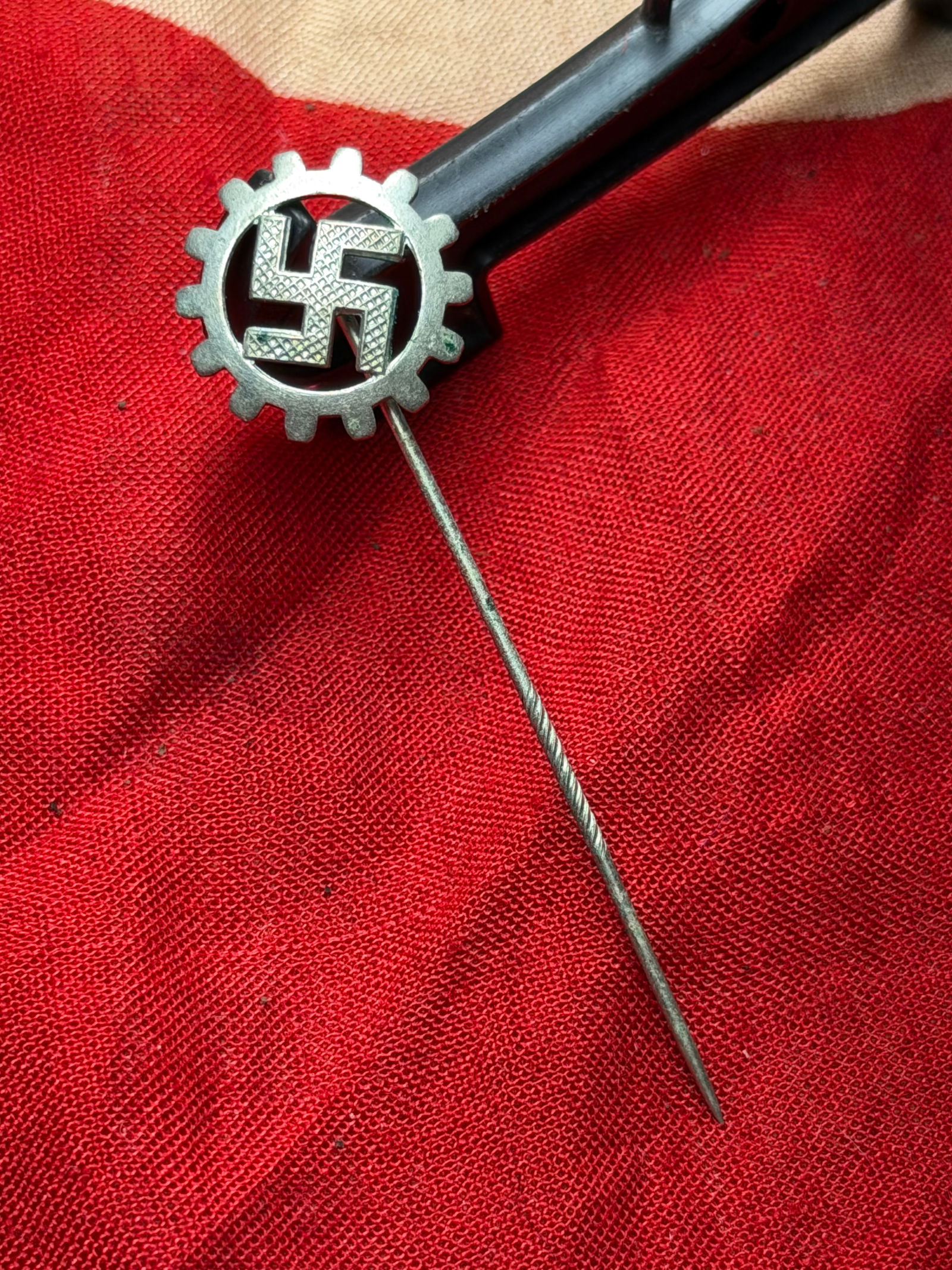 WW2 German Labor Front (DAF) Membership Stickpin: This small metal stickpin bears the emblem of the Deutsche Arbeitsfront (German Labor Front, DAF), the state-controlled labor organization established in Nazi Germany after independent trade unions we
