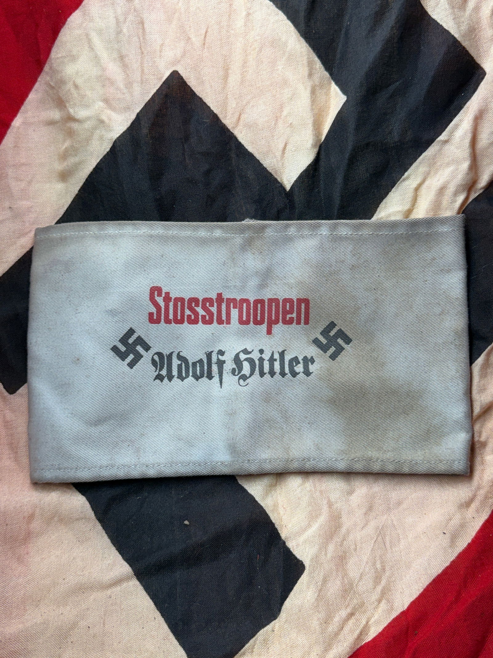 WW2 German Armband of the Stosstrupp Adolf Hitler: This armband bears the inscription “Stosstruppen Adolf Hitler” and dates to the early period of the National Socialist movement in Germany. The Stosstrupp Adolf Hitler was a small, elite bodyg
