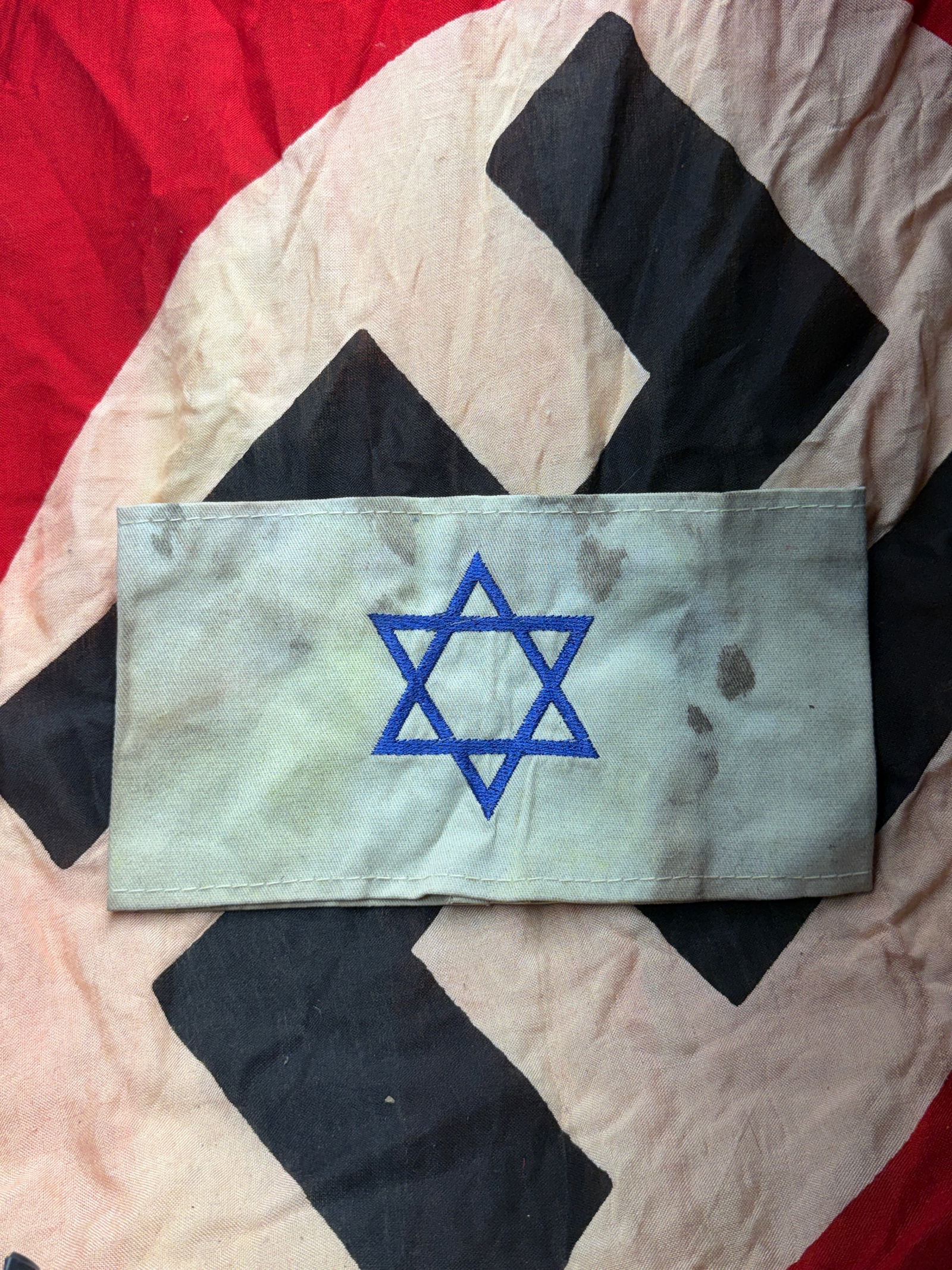 Rare WW2 German Jewish Prisoner Star Of David Armband: This cloth armband, bearing a blue Star of David, was used in Nazi-occupied Europe to forcibly identify Jewish civilians. Beginning in 1939 and increasingly standardized thereafter, Jewish men, women,