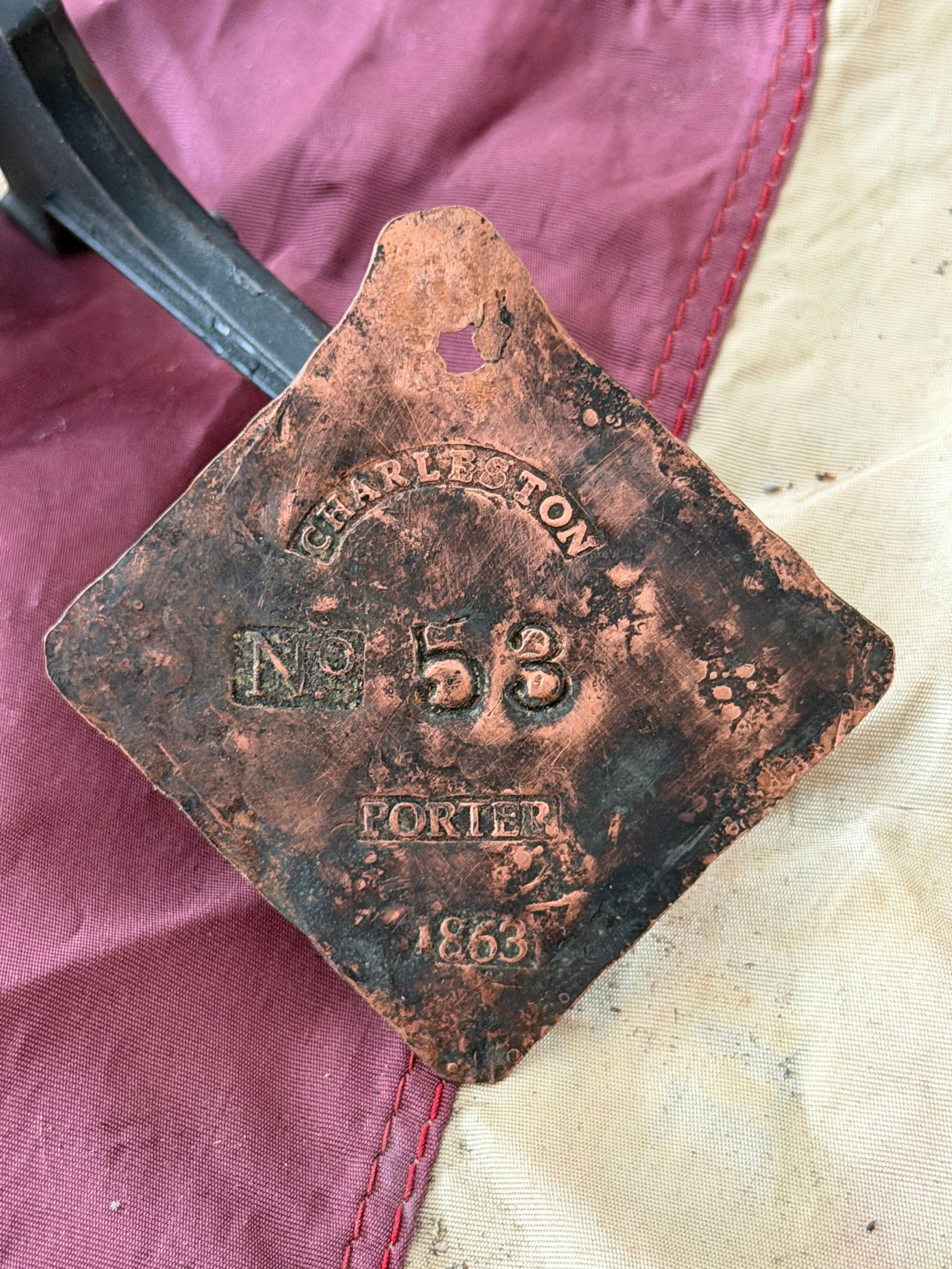Charleston Slave Tag Servant Badge, No. 53 (Porter), 1863: This copper badge is a Charleston slave badge, issued in 1863 and inscribed “CHARLESTON / No. 53 / PORTER / 1863.” Such badges were part of a municipal system in Charleston, South Carolina, th