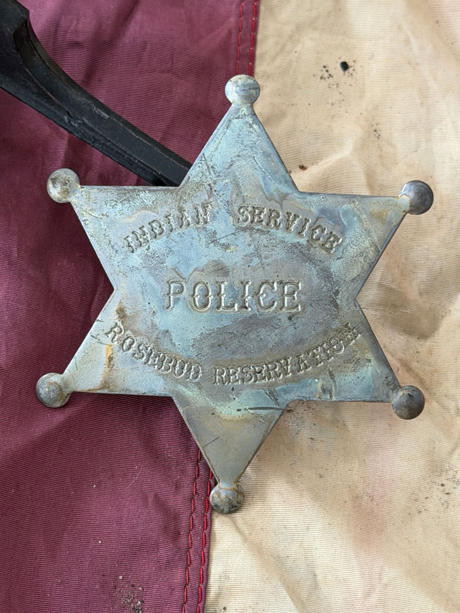 1800's Indian Service Police Badge, Rosebud Reservation: This six-pointed metal badge is inscribed “INDIAN SERVICE / POLICE / ROSEBUD RESERVATION,” identifying it as an official insignia worn by an officer of the Indian Service Police assigned to th