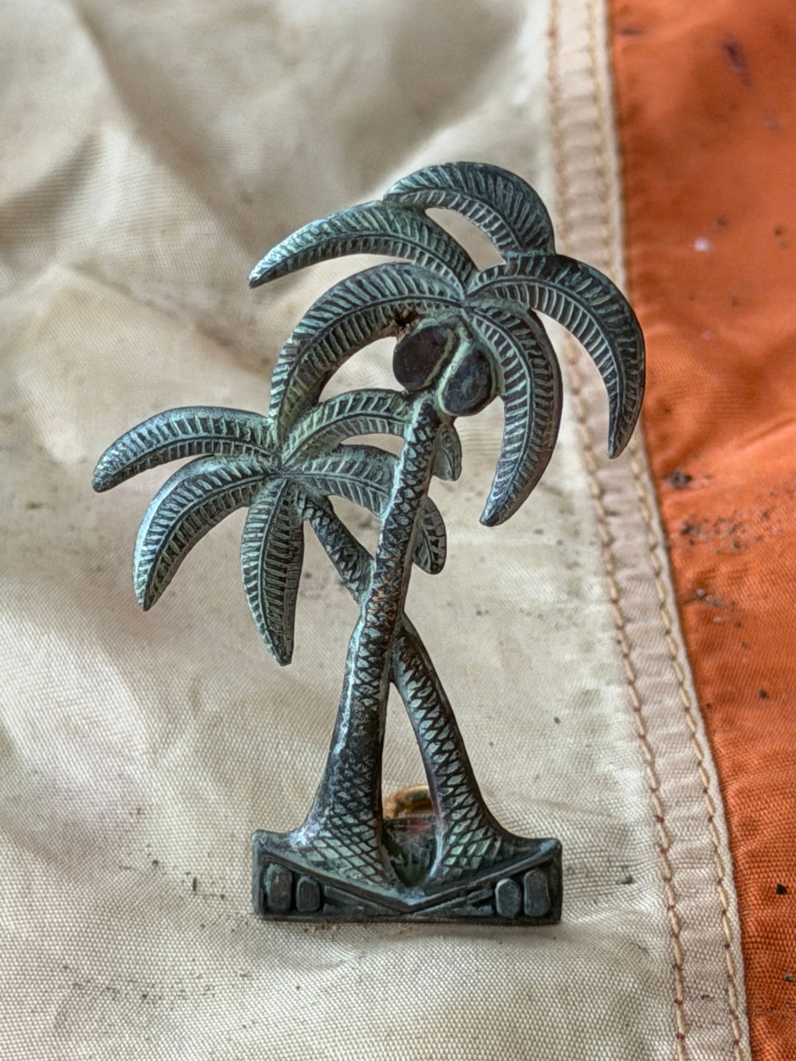 Civil War Confederate Florida Headgear Badge (Palmetto Tree Device): This cast metal headgear badge represents the State of Florida and was worn by Confederate soldiers during the American Civil War. The device depicts a stylized palmetto tree, a symbol long associated