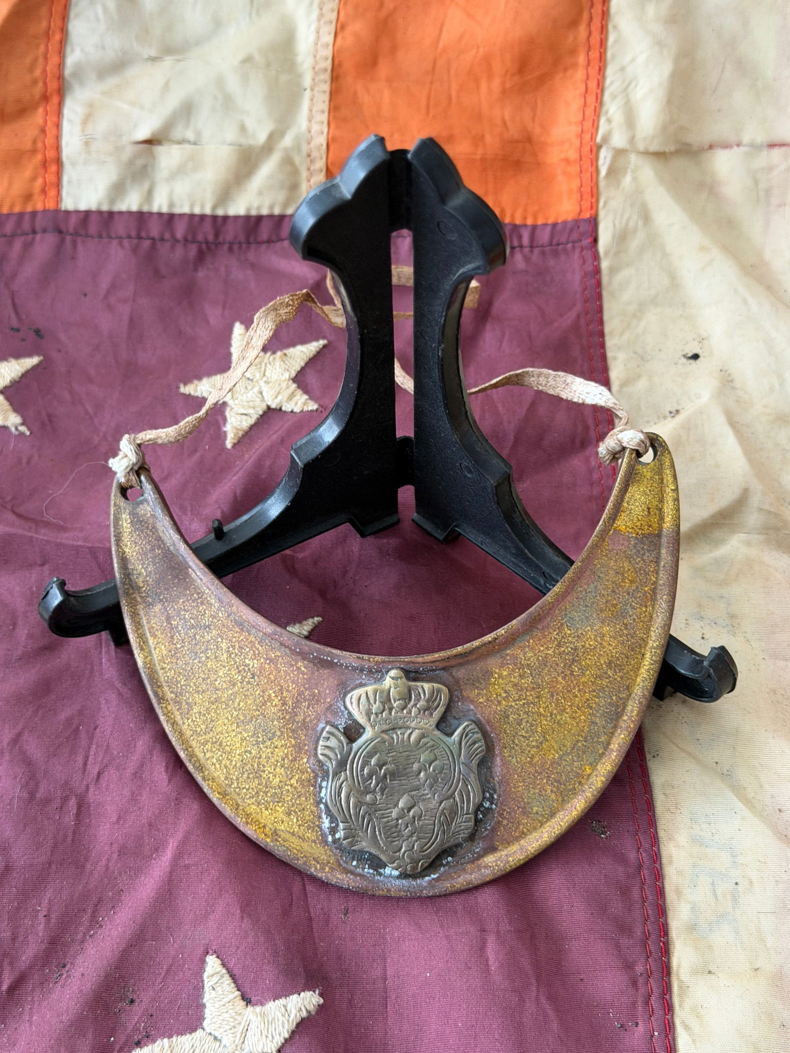 Revolutionary War Officer’s Gorget with American Eagle Device, c. 1775–1783: This rare Revolutionary War–era gorget is a crescent-shaped officer’s insignia worn at the throat, suspended by ribbons or cords as a visible mark of rank and authority. Fashioned from thin brass
