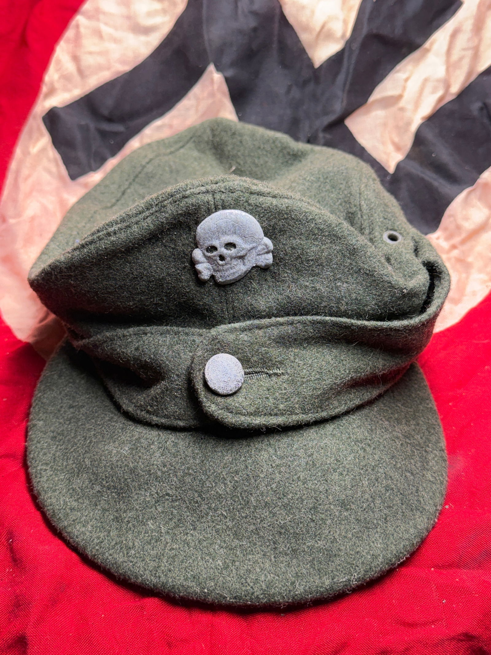 WW2 German Waffen-SS Field Cap (M43 Type): German Waffen-SS M43 field cap, introduced during the later years of the Second World War as a simplified and practical replacement for earlier headgear. Constructed of field-grey wool with a soft cro