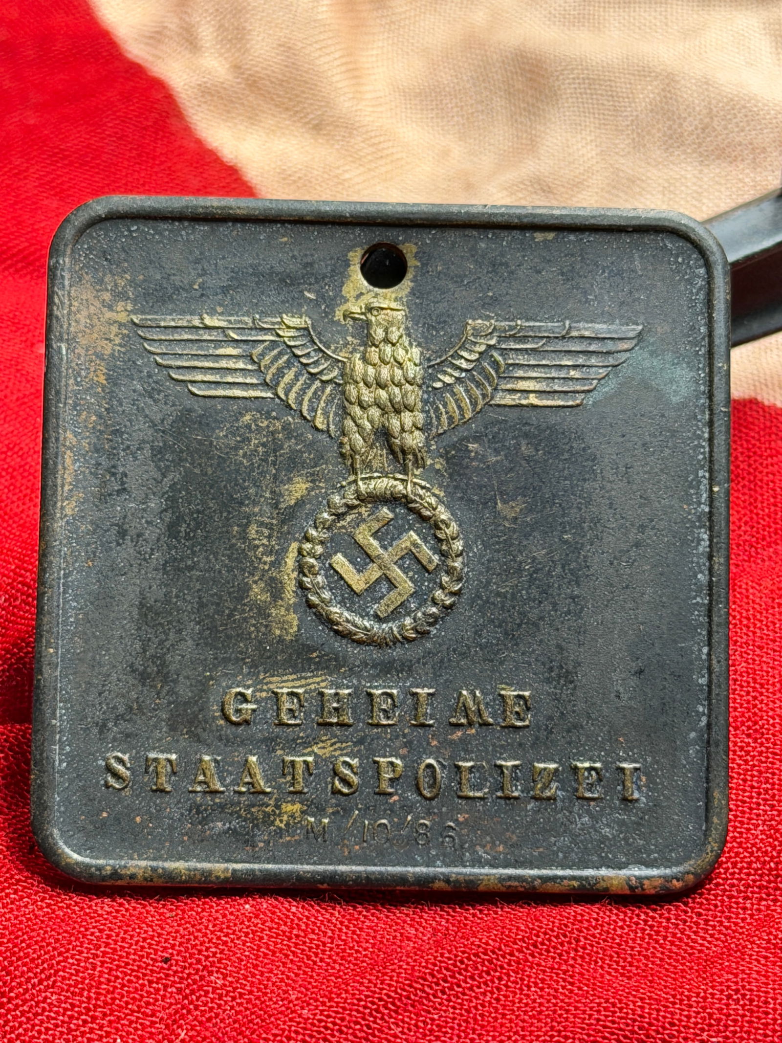 WW2 German Identification Plaque of the Gestapo (Secret State Police), Dachau: This metal identification plaque was issued by the Geheime Staatspolizei (Gestapo), the secret state police of Nazi Germany. Bearing the Reich eagle and swastika emblem on the obverse, the reverse is