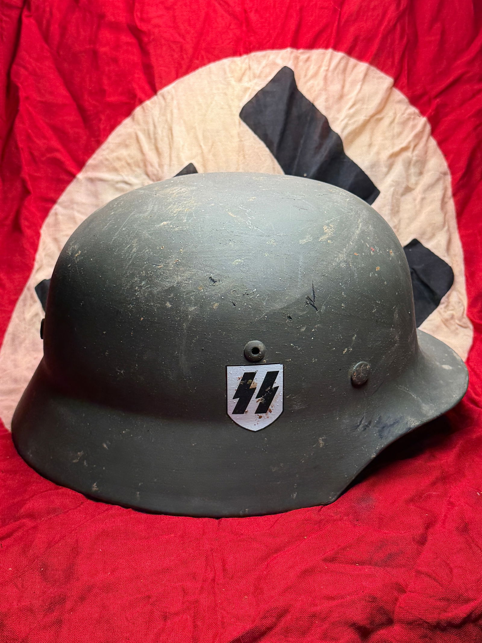 WW2 German Waffen-SS Steel Combat Helmet (Stahlhelm): German steel combat helmet (Stahlhelm) used by members of the Waffen-SS during the Second World War. The helmet is of the standard German military pattern introduced in the mid-1930s and widely issued