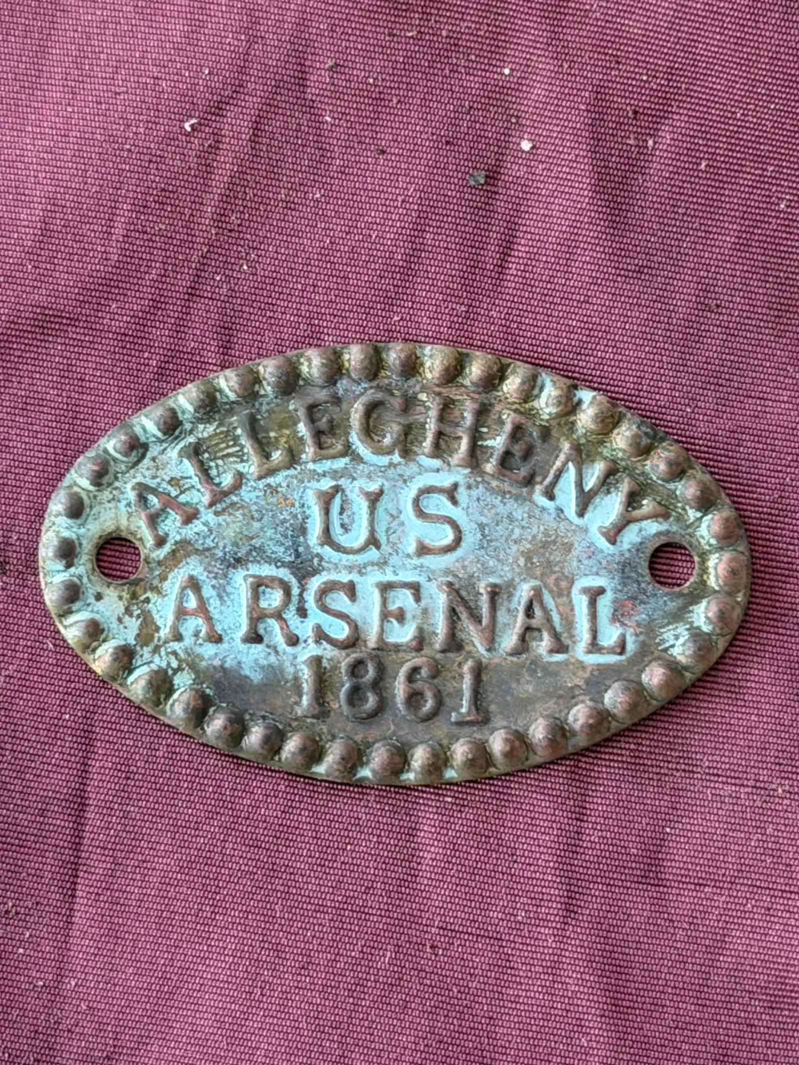 Civil War Allegheny Arsenal Identification Tag, U.S. Ordnance Department (1861): This oval brass identification tag was issued by the Allegheny Arsenal, a major United States ordnance facility located in Pittsburgh, Pennsylvania, during the opening year of the American Civil War.