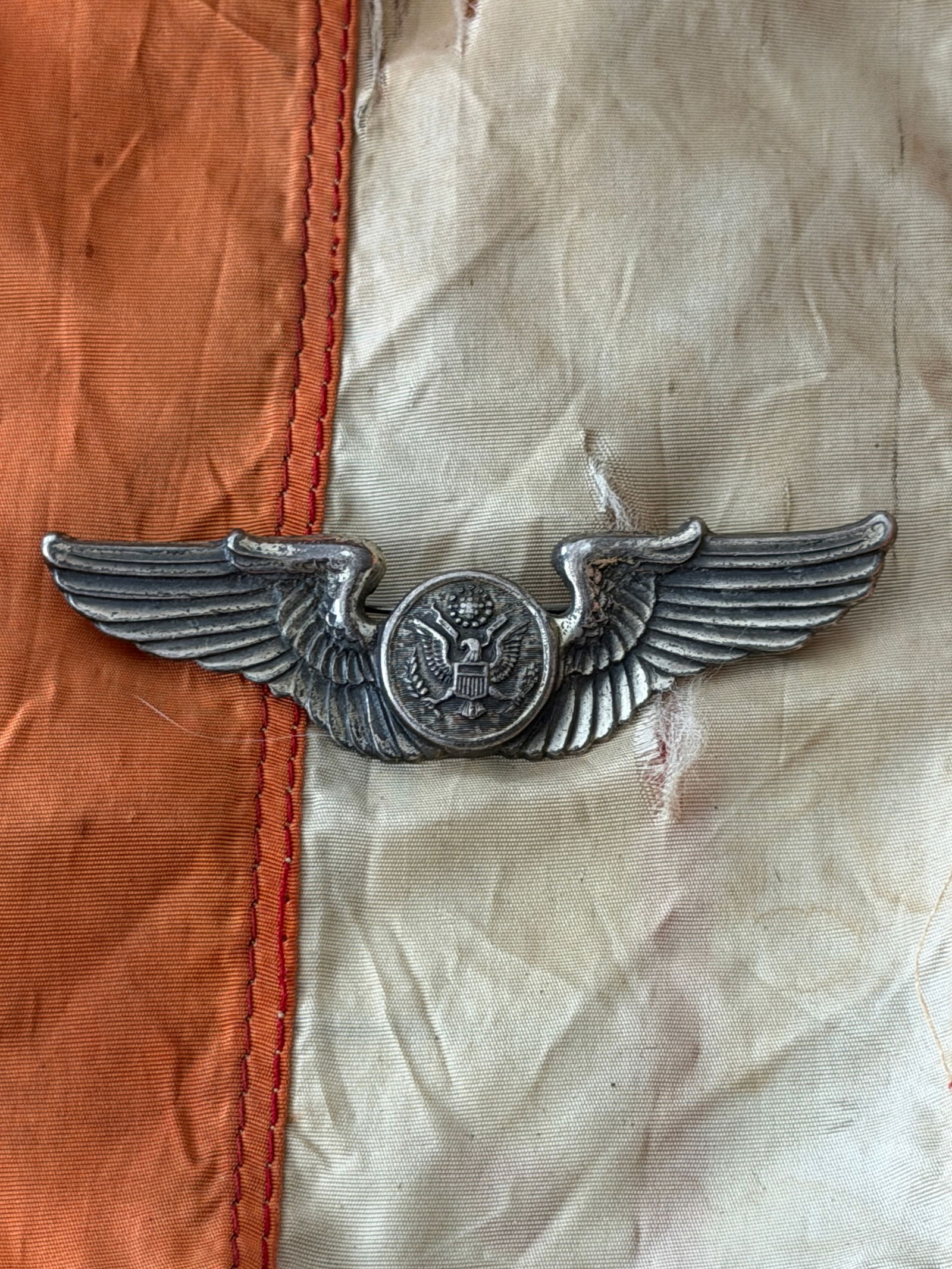 United States Army Air Forces Observer Wing Insignia, World War II: This winged insignia was worn by personnel of the United States Army Air Forces (USAAF) during World War II (1941–1945). The emblem features outstretched wings flanking a central medallion bearing t