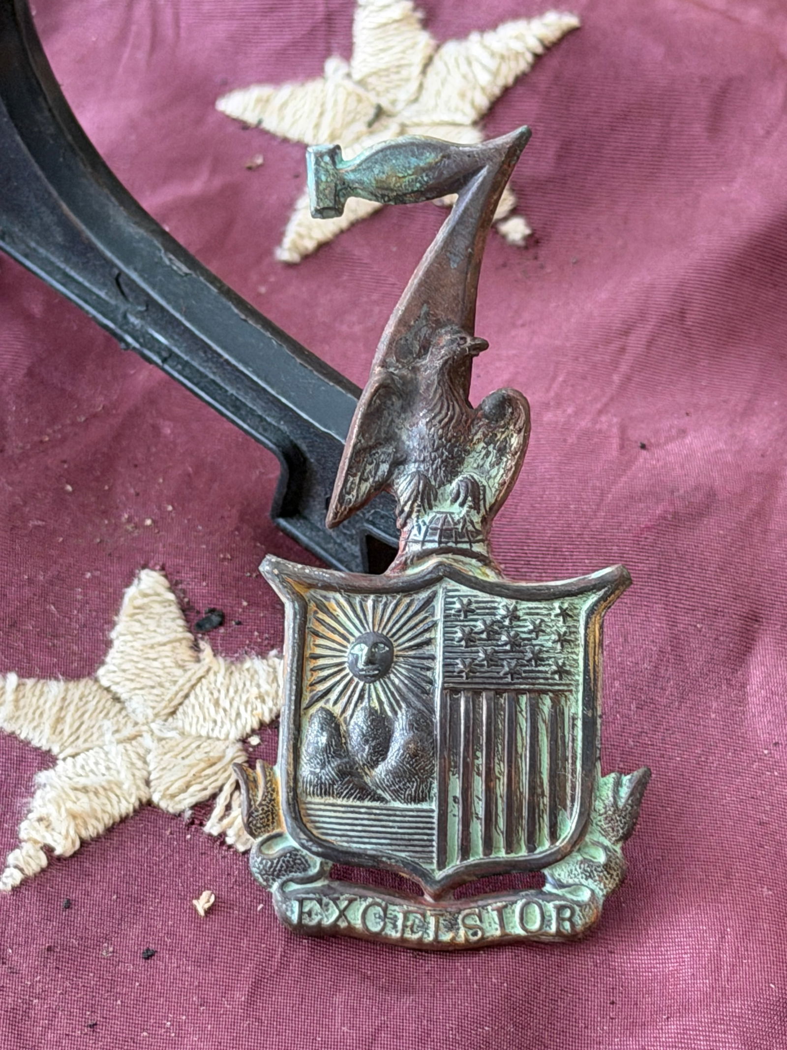 Civil War Union New York State “Excelsior?? Cap Insignia: Cast metal cap insignia associated with New York State troops serving the Union Army during the American Civil War (1861–1865). The device features an eagle perched above a shield divided into two f