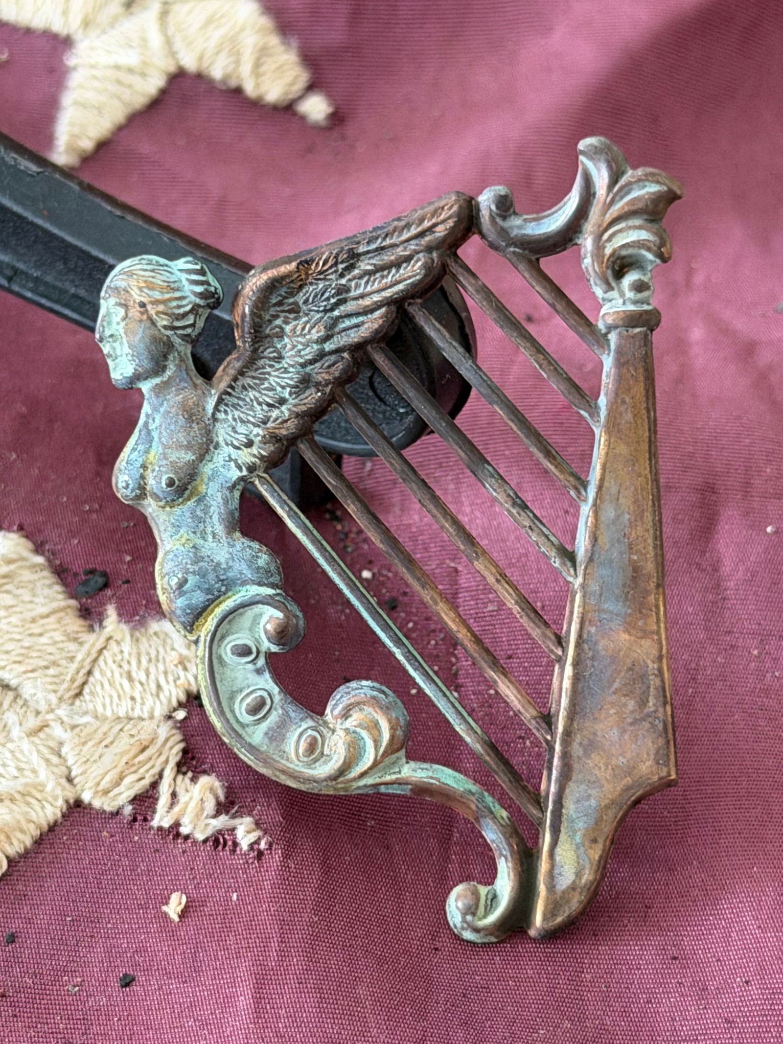 Civil War Union Irish Brigade Cap Insignia (Harp with Winged Female Figure): Cast metal headgear insignia associated with the Union Army’s Irish Brigade during the American Civil War (1861–1865). The device depicts a harp, the traditional emblem of Ireland, surmounted by a