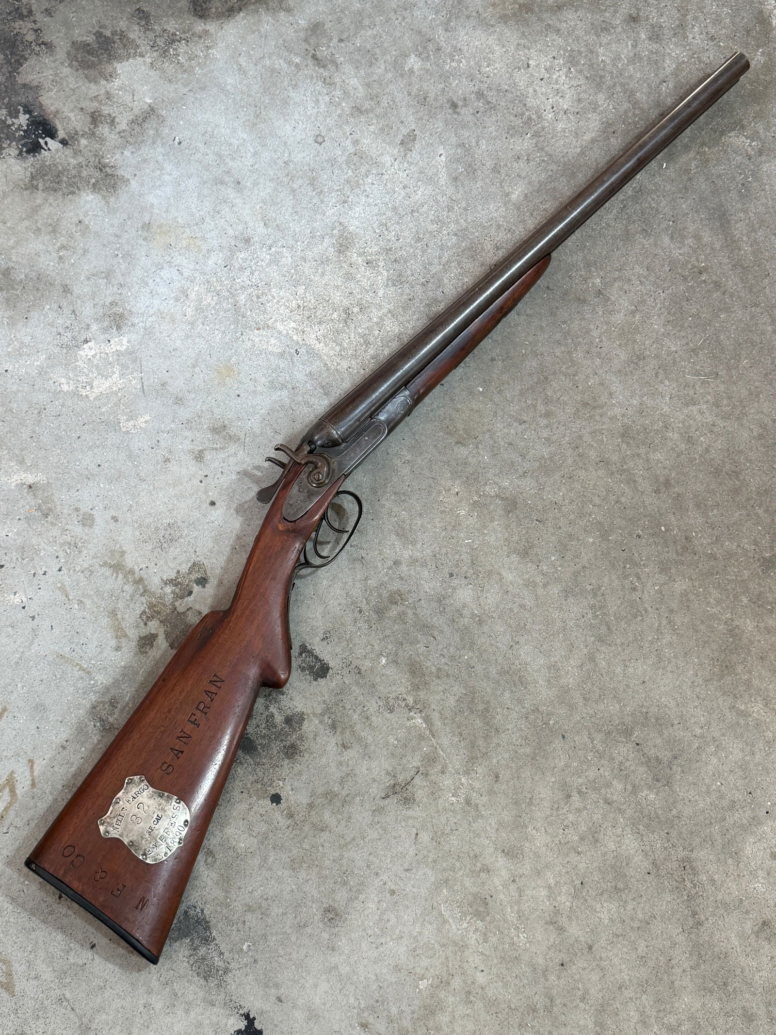 1890 Double-Barrel Shotgun Issued to Wells Fargo & Co. Express: This double-barrel percussion shotgun bears clear markings identifying it as property of Wells Fargo & Co. Express, one of the most influential transportation and security companies operating in the A