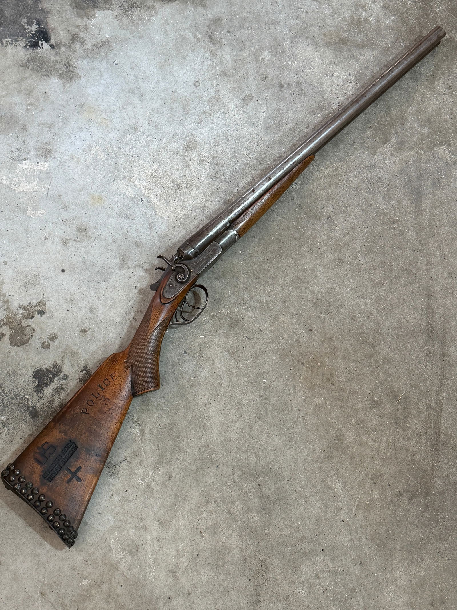1800's Double-Barrel Shotgun Issued to the U.S. Standing Rock Indian Agency Police: This double-barrel hammer shotgun bears extensive stock and barrel markings identifying it as a government-issued law-enforcement firearm associated with the Standing Rock Indian Agency, part of the U