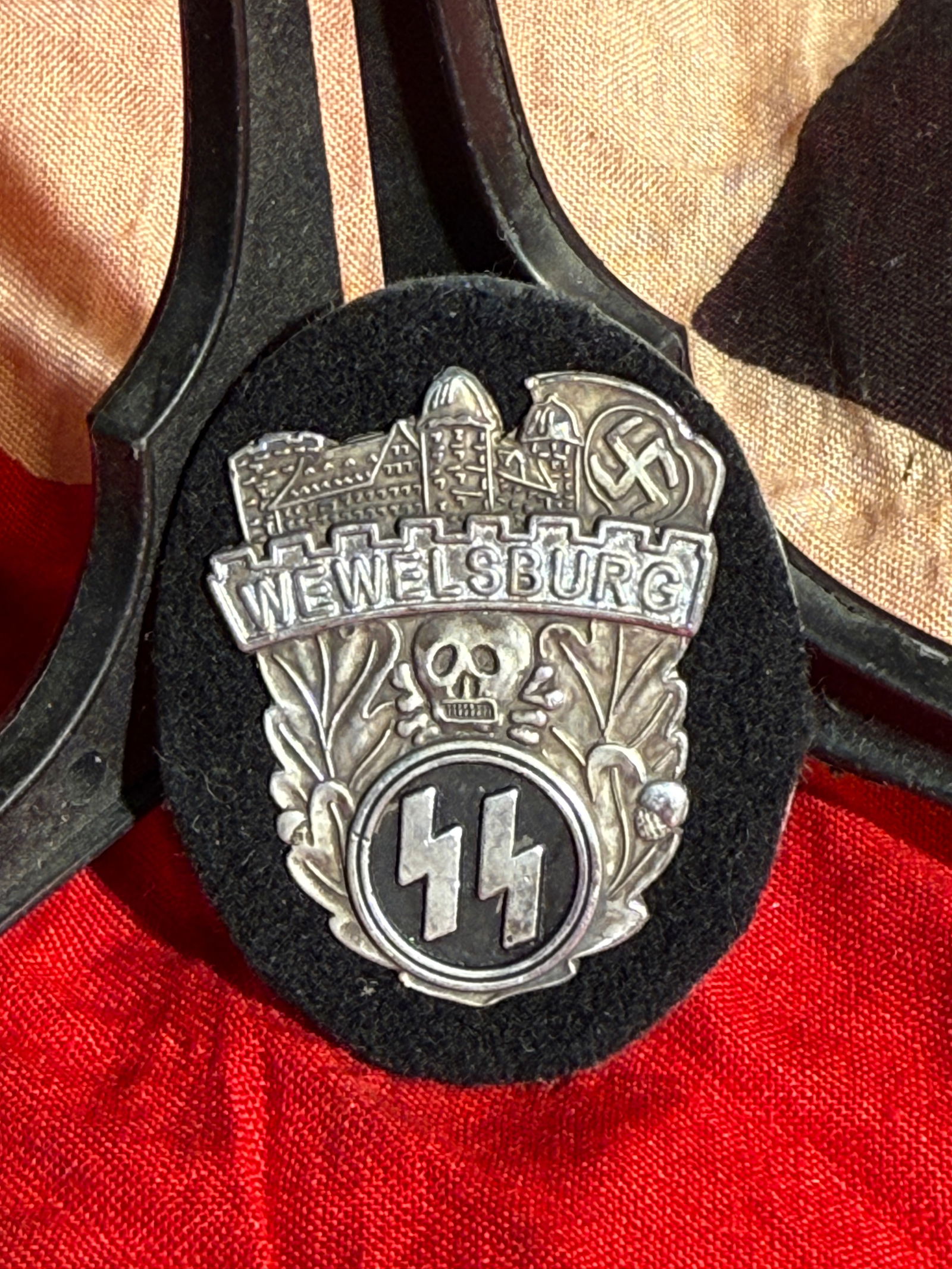 SS Wewelsburg Commemorative Badge, WW2 Germany, c. 1930s–1940s By Ges. Gesch.: German SS-related commemorative badge featuring the inscription “Wewelsburg” above a depiction of the castle complex, with an SS rune emblem within a wreath below. Maker marked Ges. Gesch. The