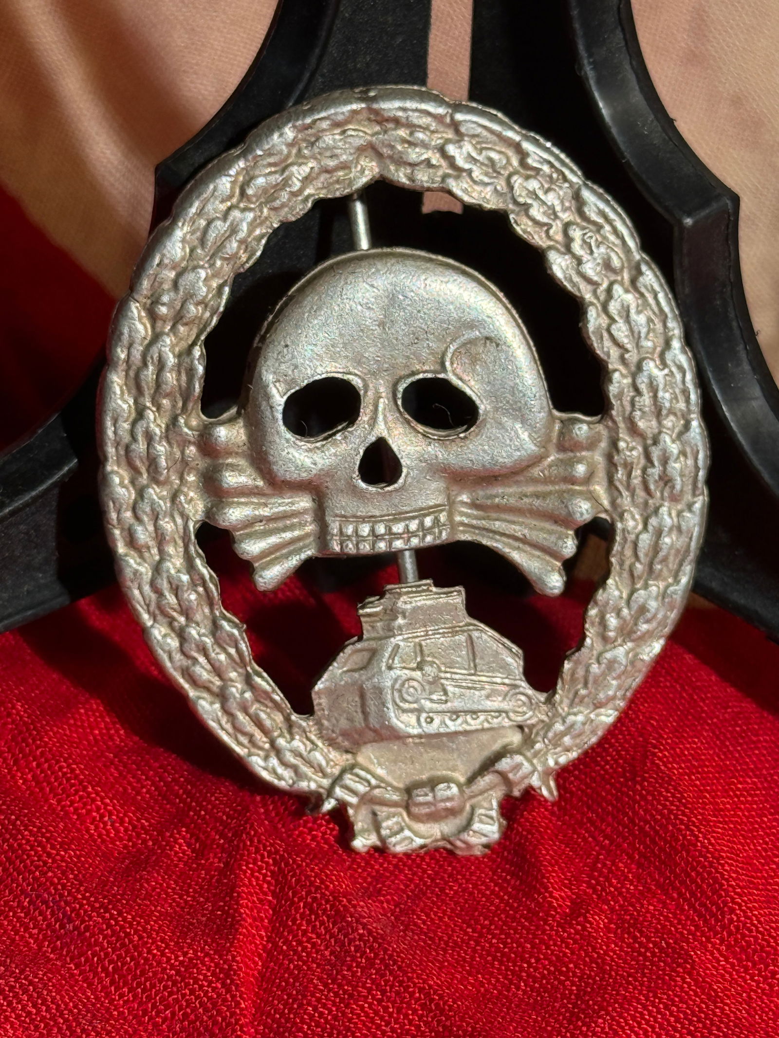 German Tank Destruction Badge (Panzervernichtungsabzeichen), WWII Era By RZM: German WWII-era Tank Destruction Badge featuring a skull and crossbones above a tank motif within a wreath. RZM maker marked. This style of badge was associated with anti-tank combat recognition and r