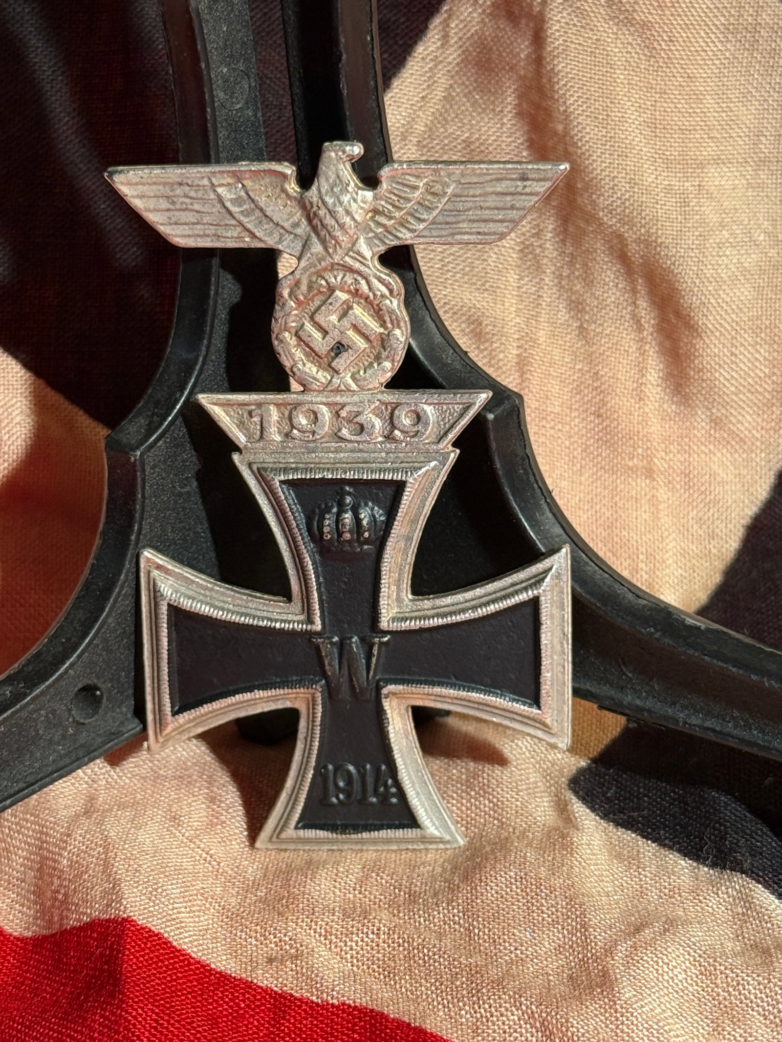 German Iron Cross 1st Class with 1939 Spange (WWI Cross Reissued in WWII) - Maker Marked: Maker Marked German Iron Cross 1st Class featuring the 1914 cross with crowned “W” and date “1914,” fitted with a 1939 eagle and swastika spange above, indicating the award was reissue