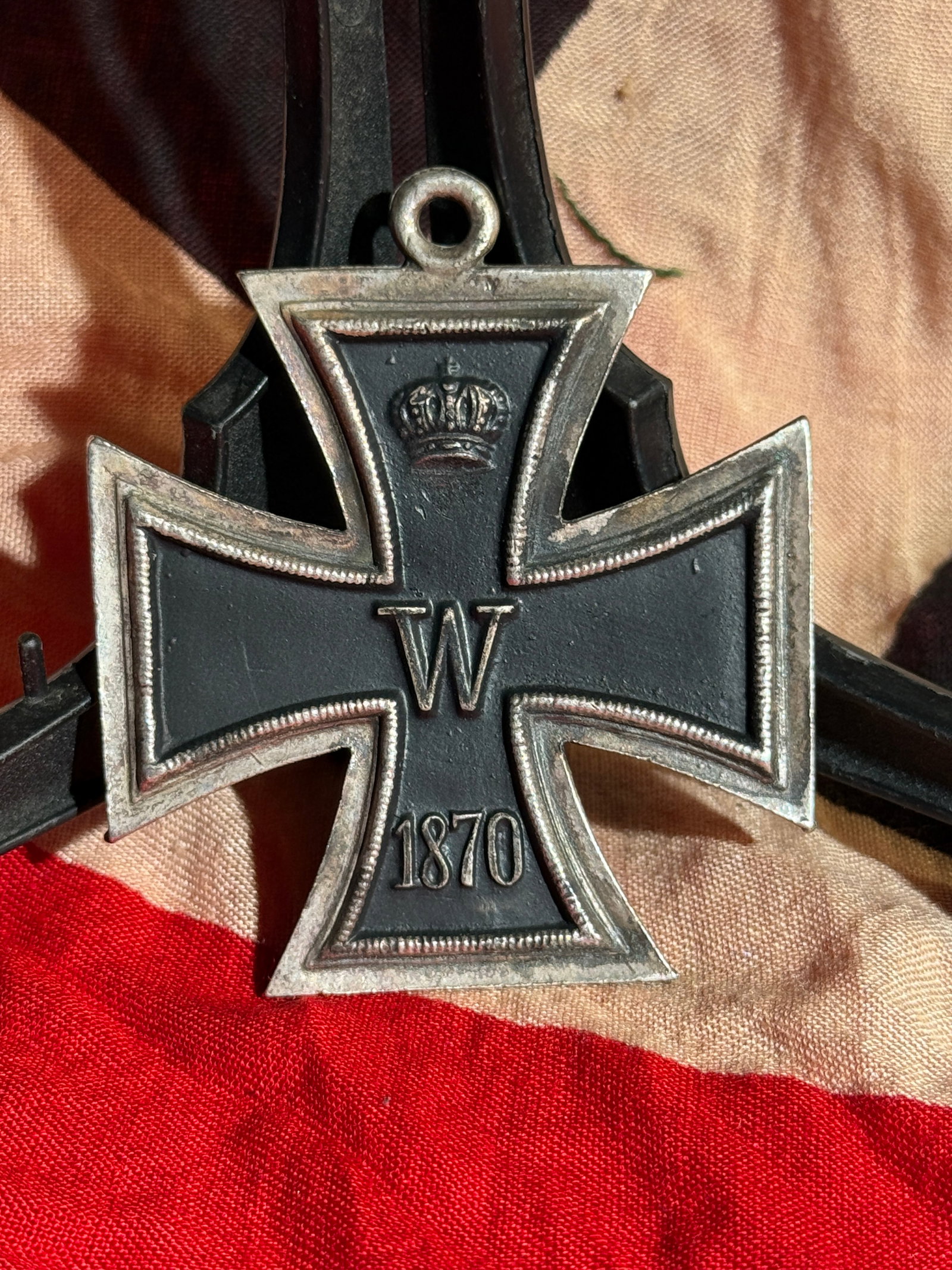Prussian Iron Cross, Franco-Prussian War (1870 Model): Prussian Iron Cross from the Franco-Prussian War (1870–1871) issued under King Wilhelm I. The obverse displays the crowned royal cipher “W” and the date 1870, while the reverse shows “FW&r