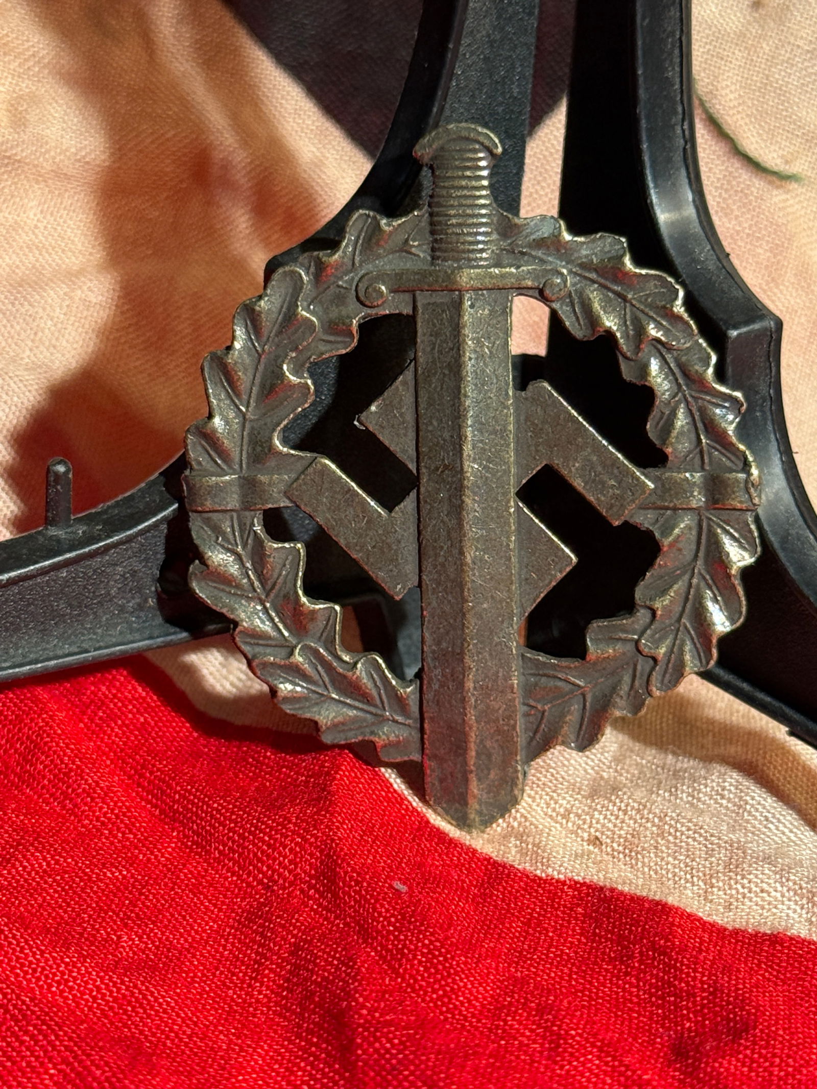 WW2 German SA Sports Badge in Bronze (SA-Sportabzeichen), Nazi Germany, c. 1933–1945 - Maker: Bronze SA Sports Badge awarded by the Sturmabteilung (SA) to individuals who passed a series of physical fitness and paramilitary tests. Maker marked on the reverse. The design features a vertical swo