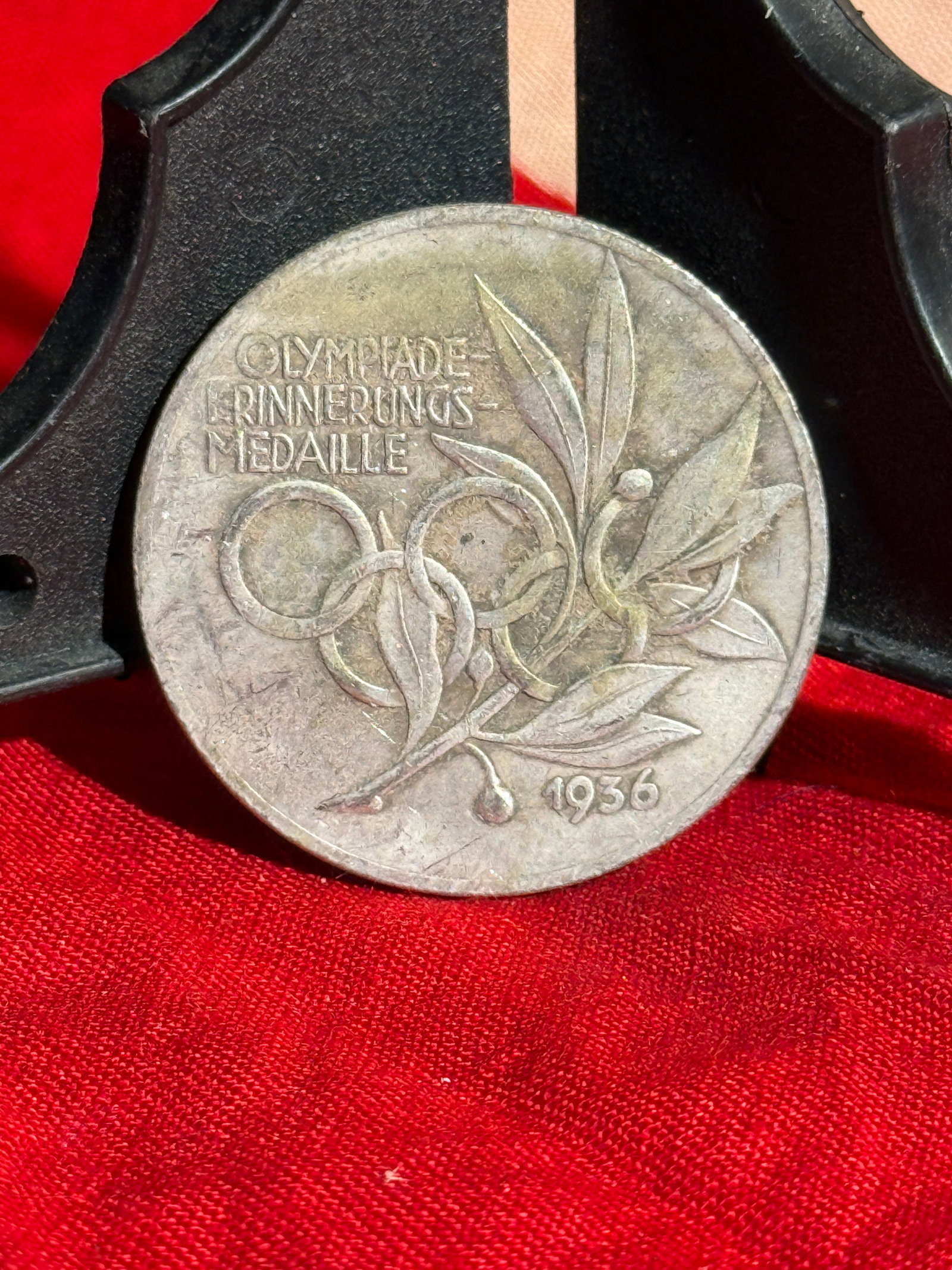 1936 Berlin Olympic Games Commemorative Medal (Olympiade-Erinnerungsmedaille): Commemorative medal issued for the 1936 Summer Olympic Games held in Berlin, Germany. The obverse features the inscription “Olympiade-Erinnerungs-Medaille” above the Olympic rings intertwined 