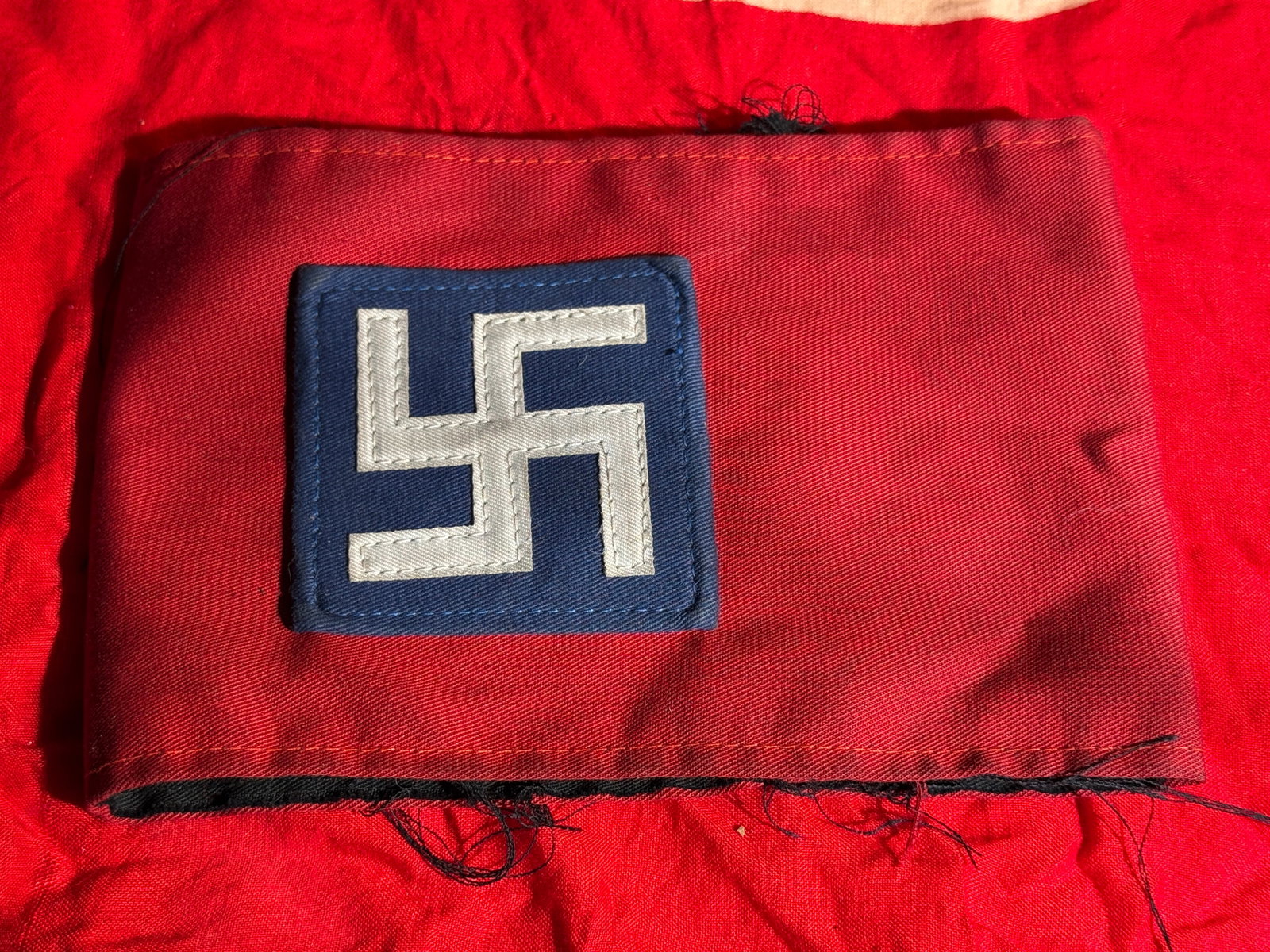 WW2 German NSDAP Armband with Political Leader Insignia, Nazi Germany, c. 1933–1945: Red cloth National Socialist German Workers’ Party (NSDAP) armband featuring a blue square patch bearing a white swastika appliqué. Variations of armbands with colored patches were worn by Nazi Par