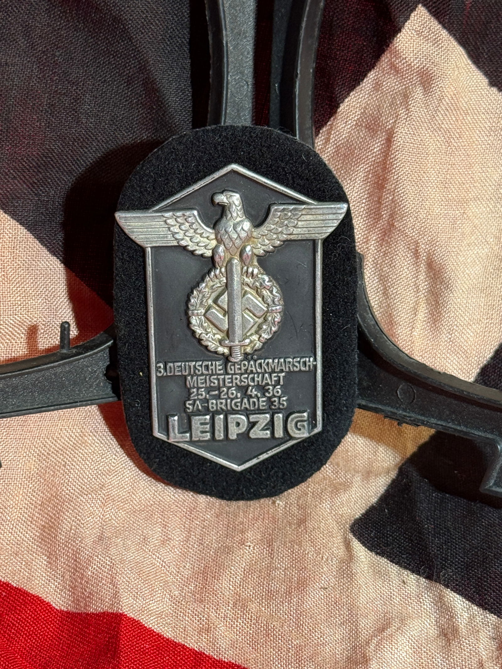 WW2 German SA “3rd German Pack March Championship?? Badge, Leipzig, 1936 By RZM: Metal participation badge issued for the 3rd Deutsche Gepäckmarsch-Meisterschaft (German Pack March Championship) held 25–26 April 1936 in Leipzig and organized by SA Brigade 85 of the Sturmabteilu