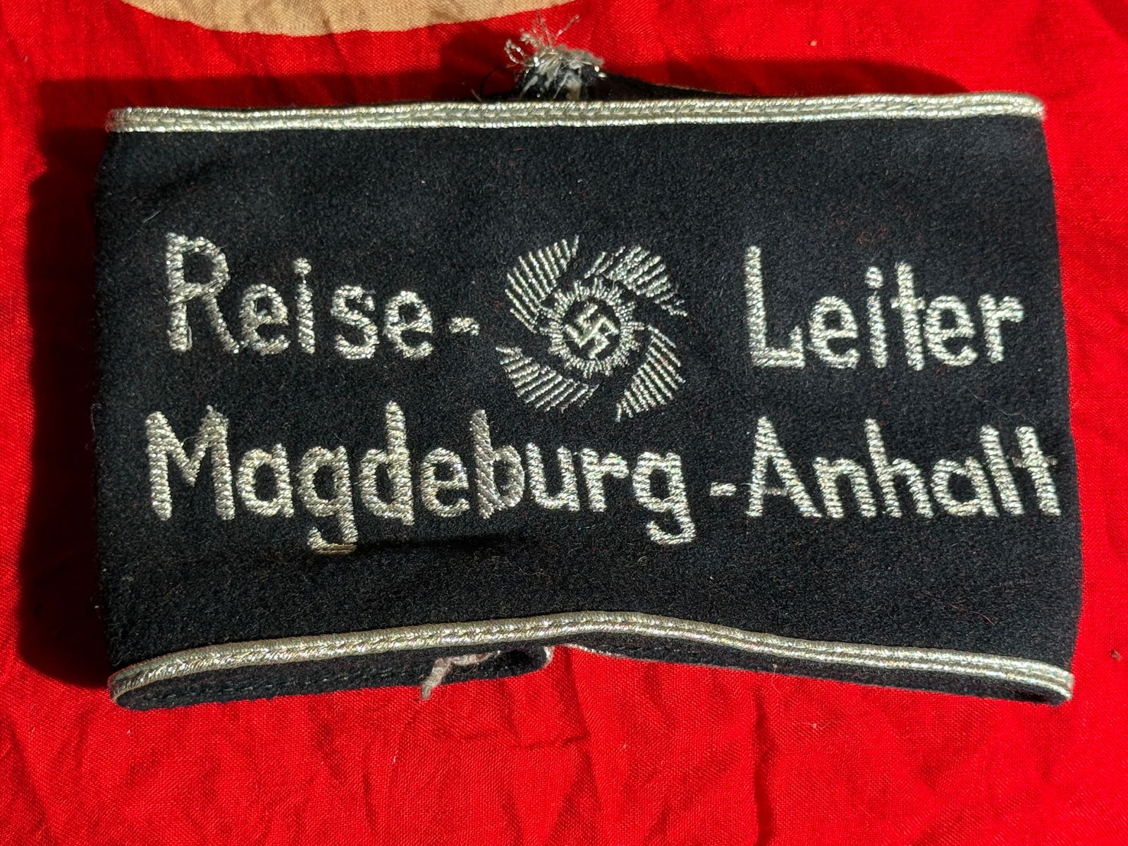 WW2 German NSDAP Kreisleiter Armband, Magdeburg-Anhalt District, Third Reich With RZM Paper Tag: Black wool Nazi Party (NSDAP) political leader armband embroidered in silver thread with the title “Kreis-Leiter Magdeburg-Anhalt” and a central NSDAP party emblem. The term Kreisleiter design
