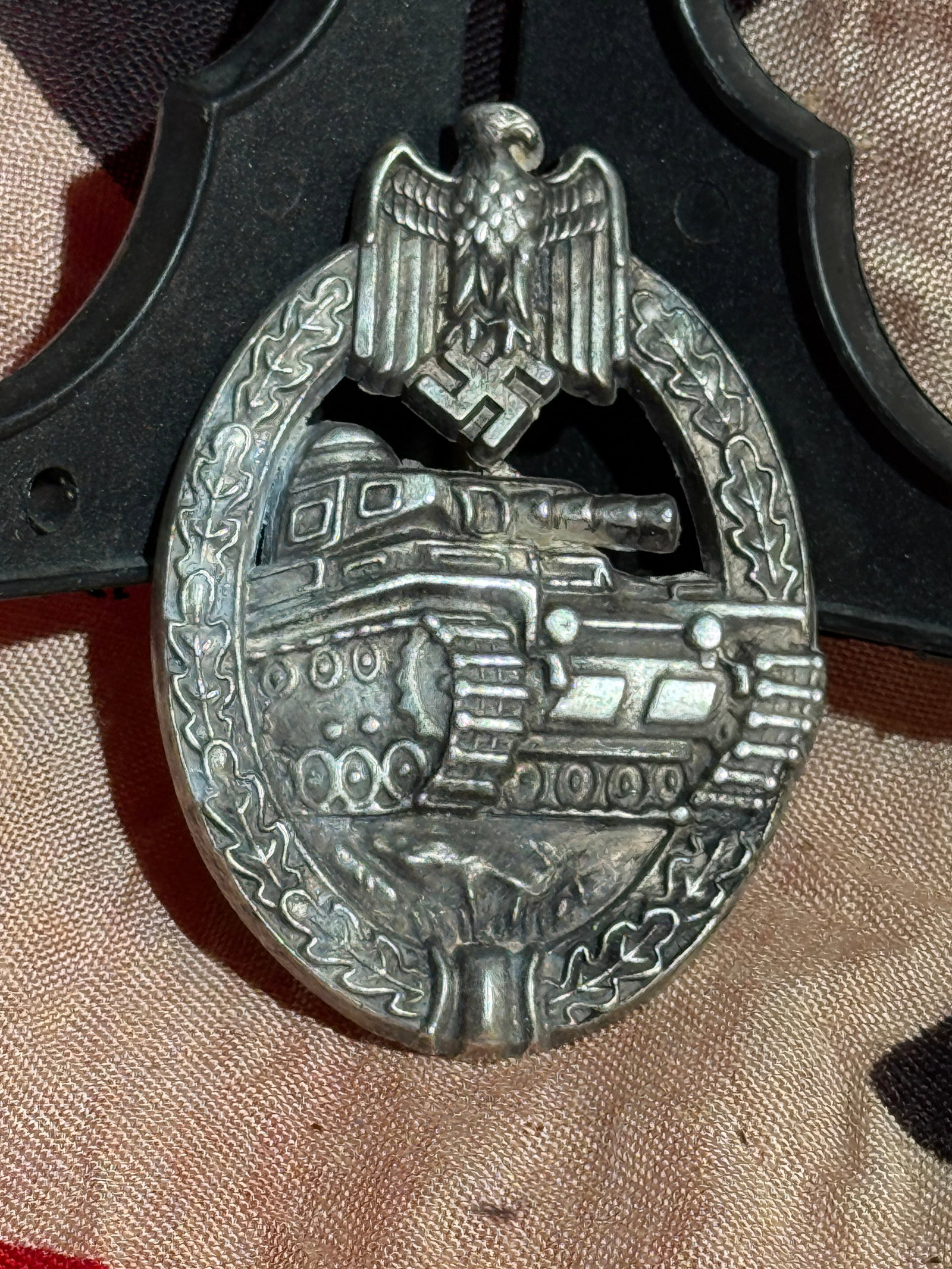 WW2 German Panzer Assault Badge (Panzerkampfabzeichen), Wehrmacht, World War II: Oval Panzer Assault Badge (Panzerkampfabzeichen) awarded to members of German armored units during World War II. The badge features a detailed relief of a German Panzer tank advancing forward, surroun