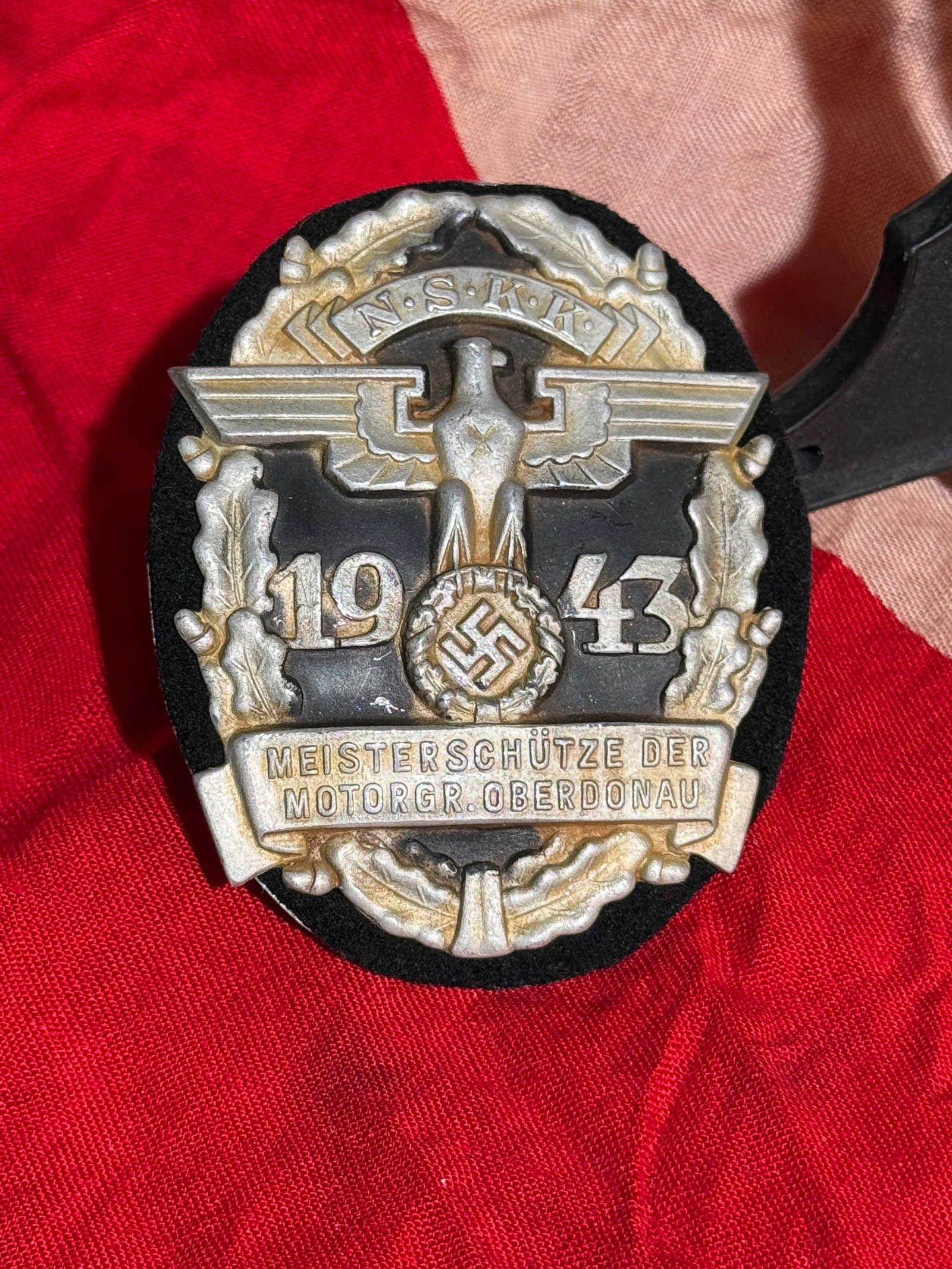 WW2 German NSKK Motor Group Oberdonau Master Marksman Badge, 1943 By RZM: Commemorative Nationalsozialistisches Kraftfahrkorps (NSKK) shooting award badge dated 1943, recognizing a “Meisterschütze” (Master Marksman) within the Motorgruppe Oberdonau, a regional unit