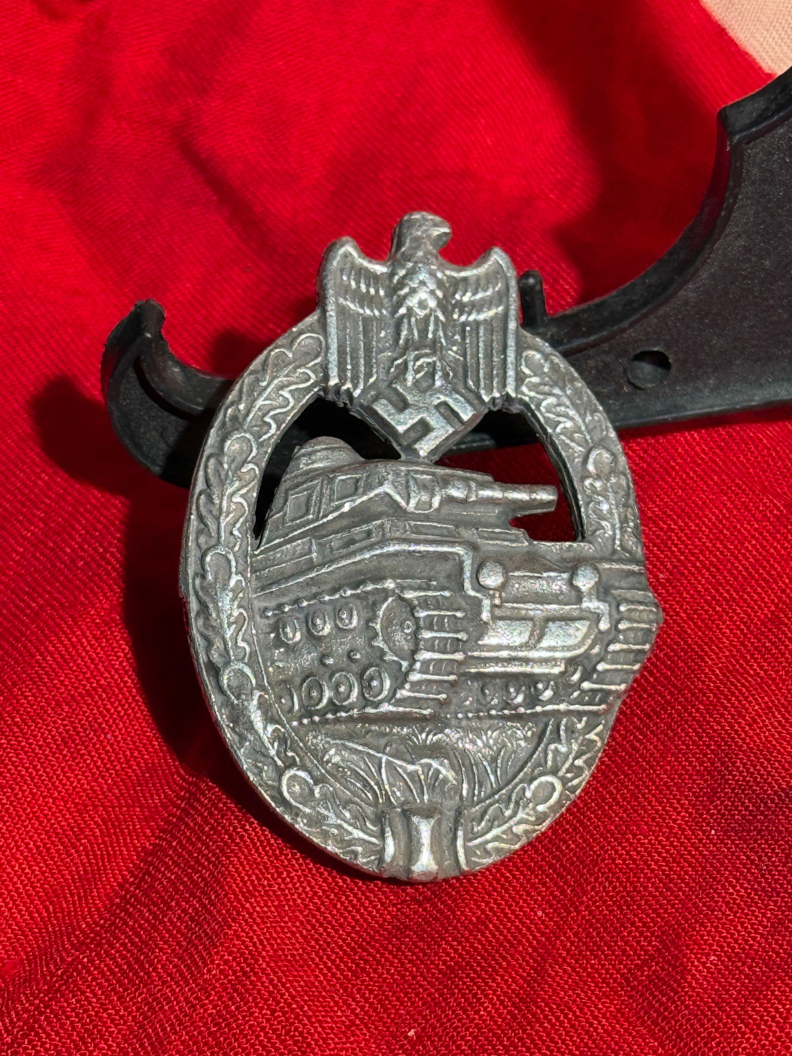 WW2 German Panzer Assault Badge (Panzerkampfabzeichen), World War II Era, c. 1939–1945: Military combat badge issued to members of the German armored forces during the Second World War. The badge features a detailed depiction of a Panzer tank advancing forward, framed by an oak leaf wrea
