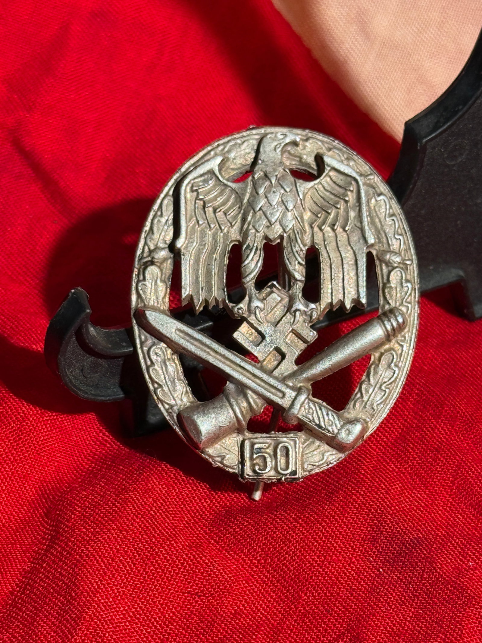 WW2 German General Assault Badge with “50?? Engagement Clasp, World War II, c. 1943–1945 By RZM: Military combat badge of Nazi Germany known as the General Assault Badge (Allgemeines Sturmabzeichen), featuring the national eagle above a swastika and crossed infantry weapons within an oak leaf wre