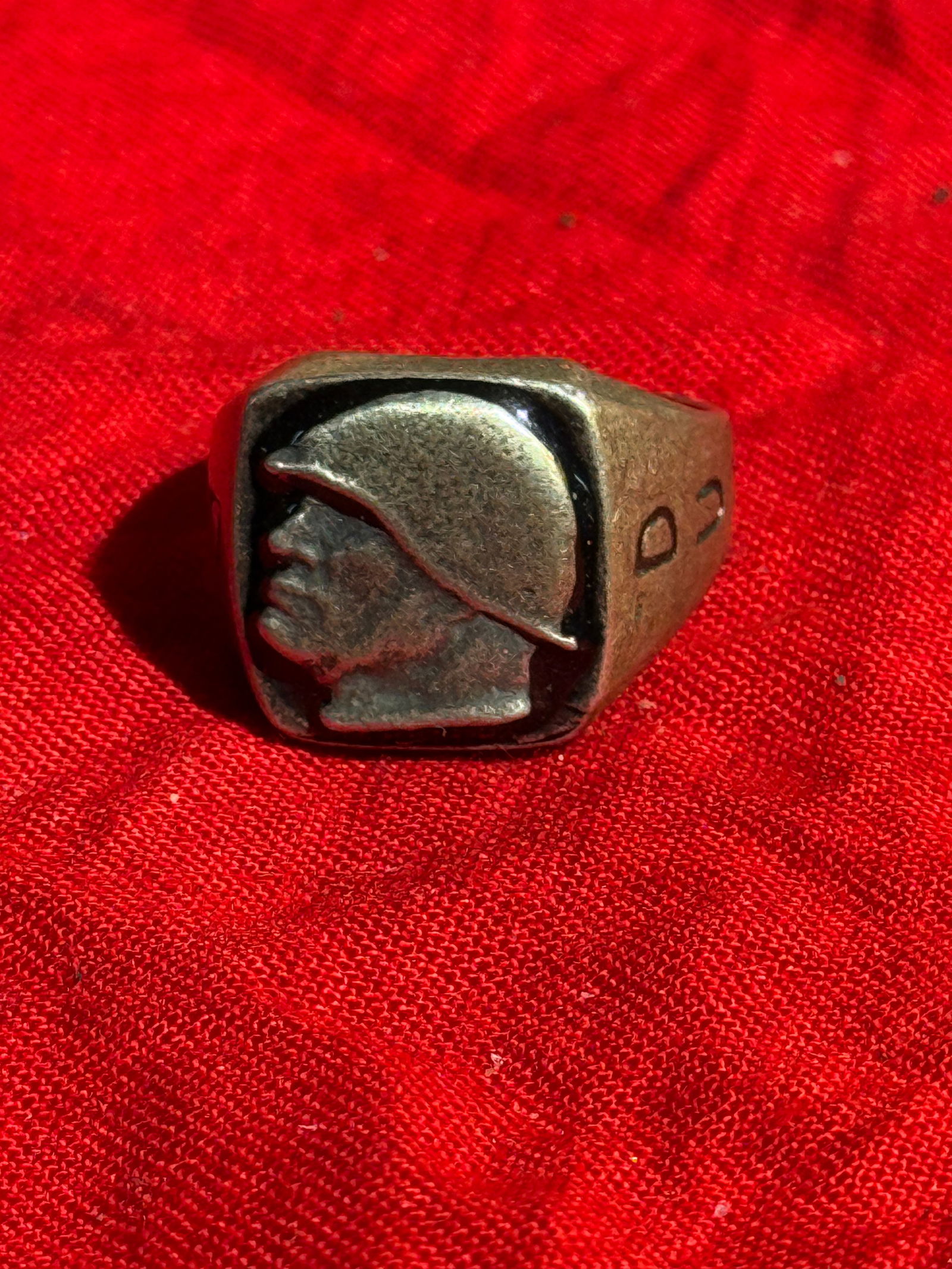 World War II U.S. Army Infantry “D.U.X.?? Sweetheart or Veteran’s Ring: A World War II–era U.S. Army infantry ring featuring a raised profile of a helmeted American soldier on the bezel. The shoulders of the band are engraved with the letters “D U X,” commonly i