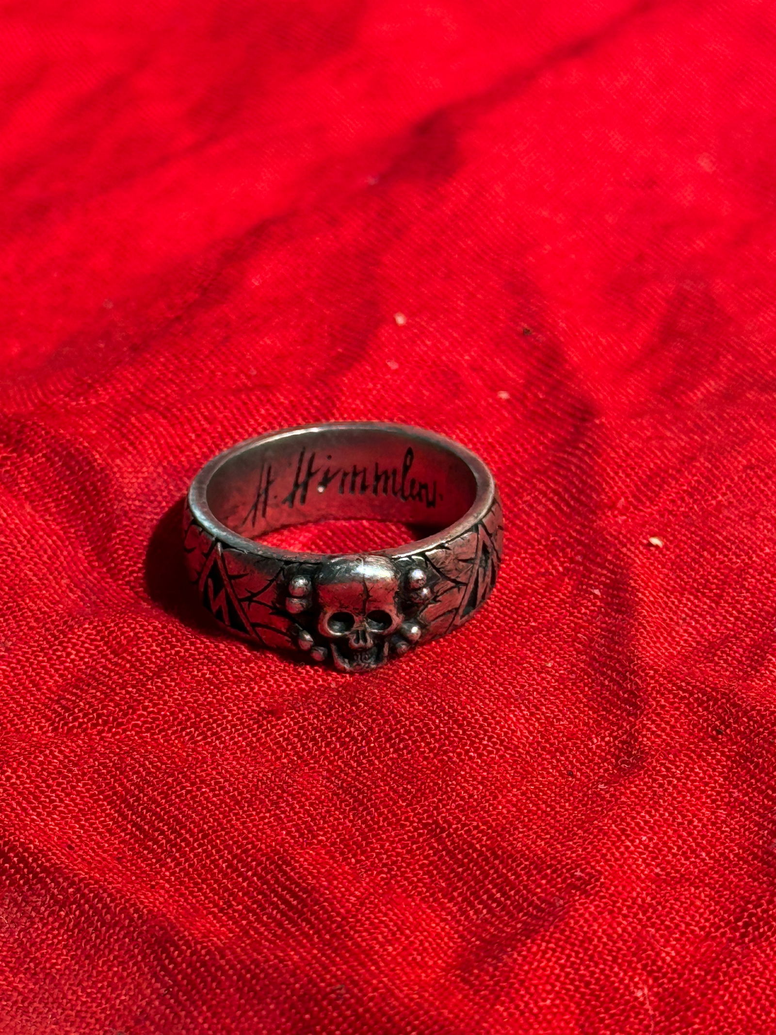 WW2 German SS Totenkopf Ring (Honor Ring) Associated with Heinrich Himmler: Metal SS Totenkopf (Death’s Head) ring, a style associated with the Schutzstaffel (SS) during the Third Reich period (1933–1945). The ring features a central skull motif (Totenkopf) surrounded by