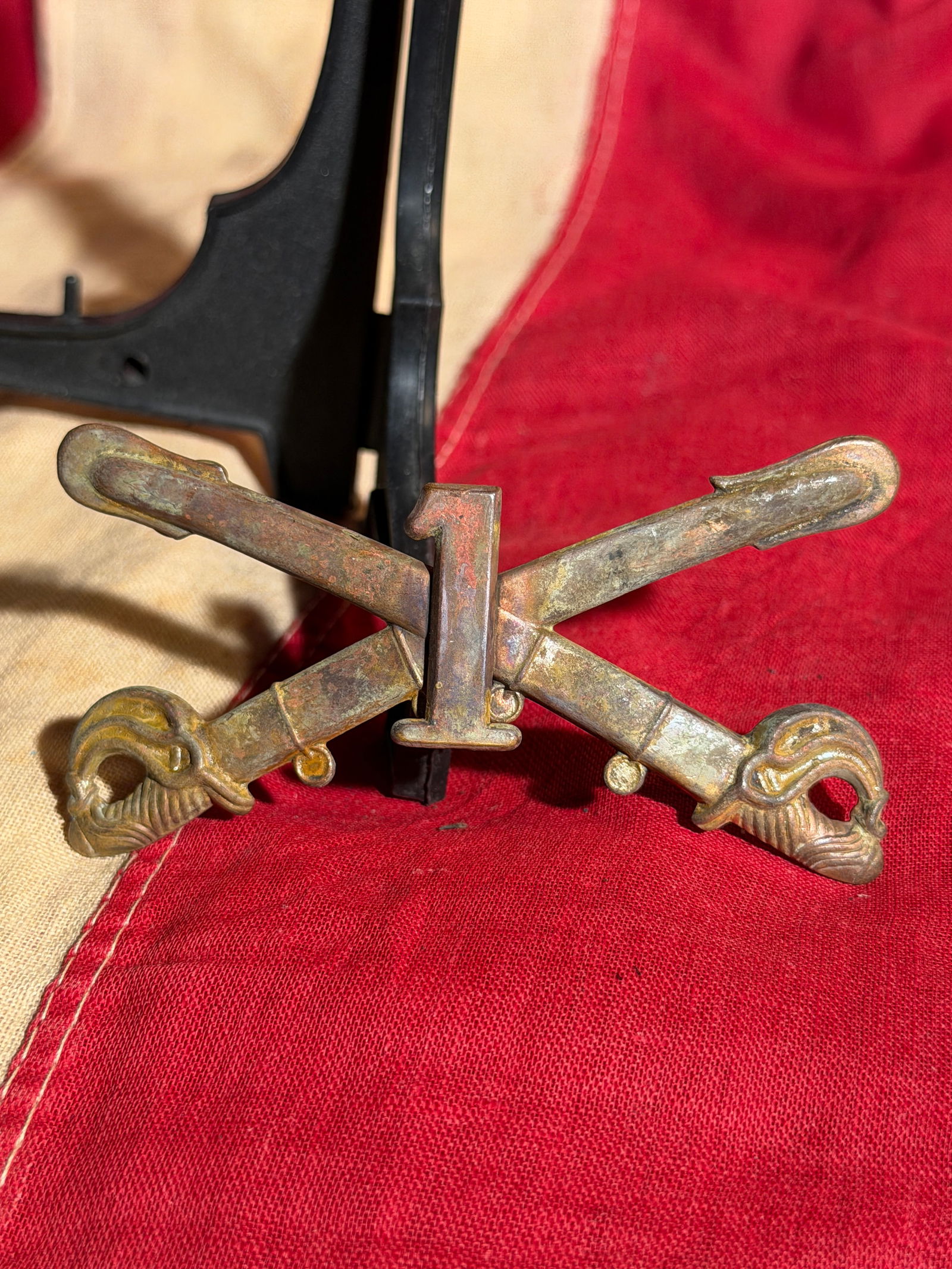 Civil War Union U.S. 1st Cavalry Regiment Crossed Sabers Insignia: Civil War Cast brass military insignia featuring crossed cavalry sabers with a raised numeral “1”, indicating the 1st Cavalry Regiment of the United States Army. The sabers display detailed gr