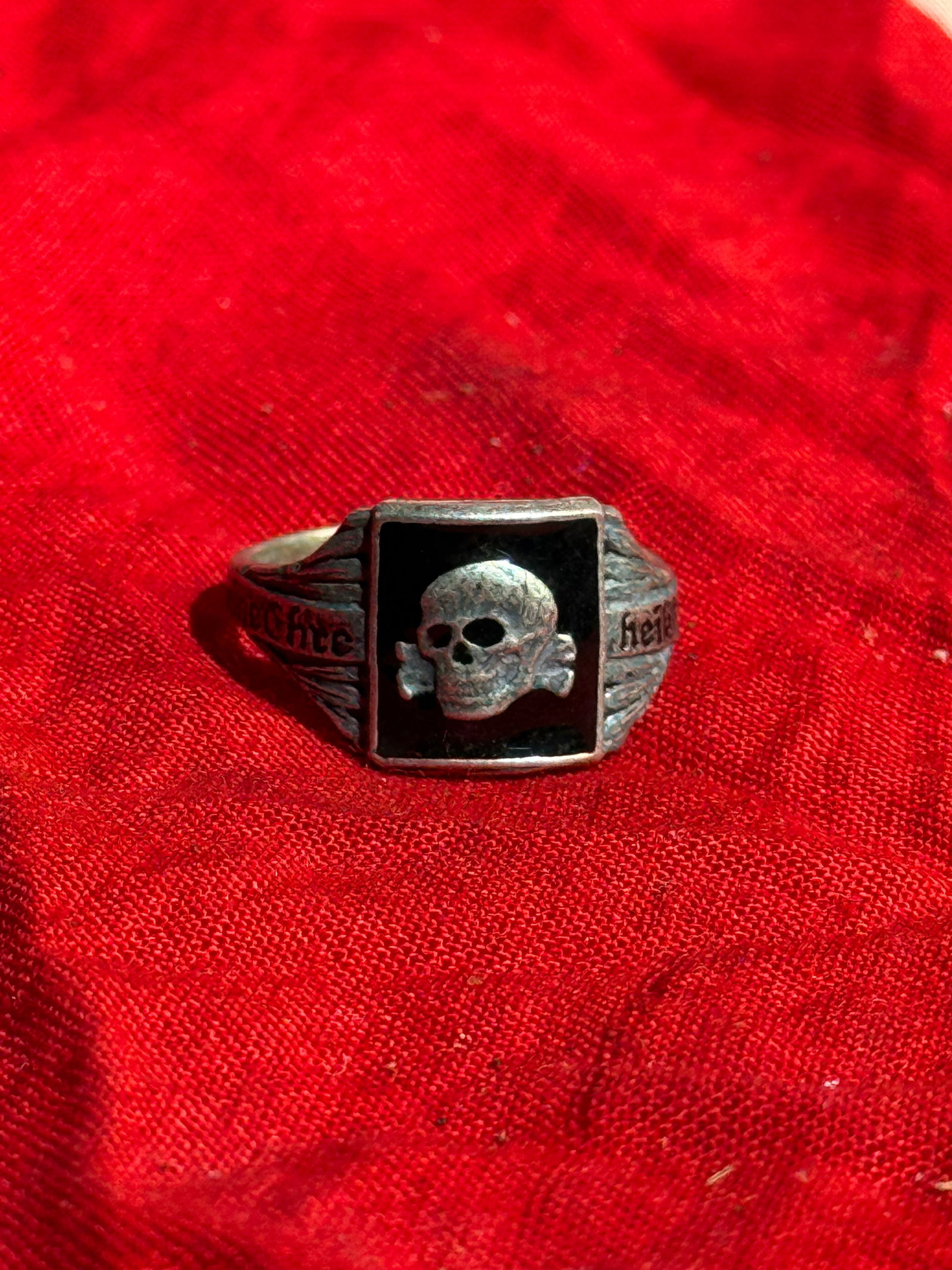 WW2 German Totenkopf (“Death’s Head??) Ring in the Style of the SS Honor Ring (Totenkopfring): Silver ring featuring a raised skull and crossbones (Totenkopf) set against a black background, a symbol associated with elite military units in Germany and later adopted by the Schutzstaffel (SS) dur