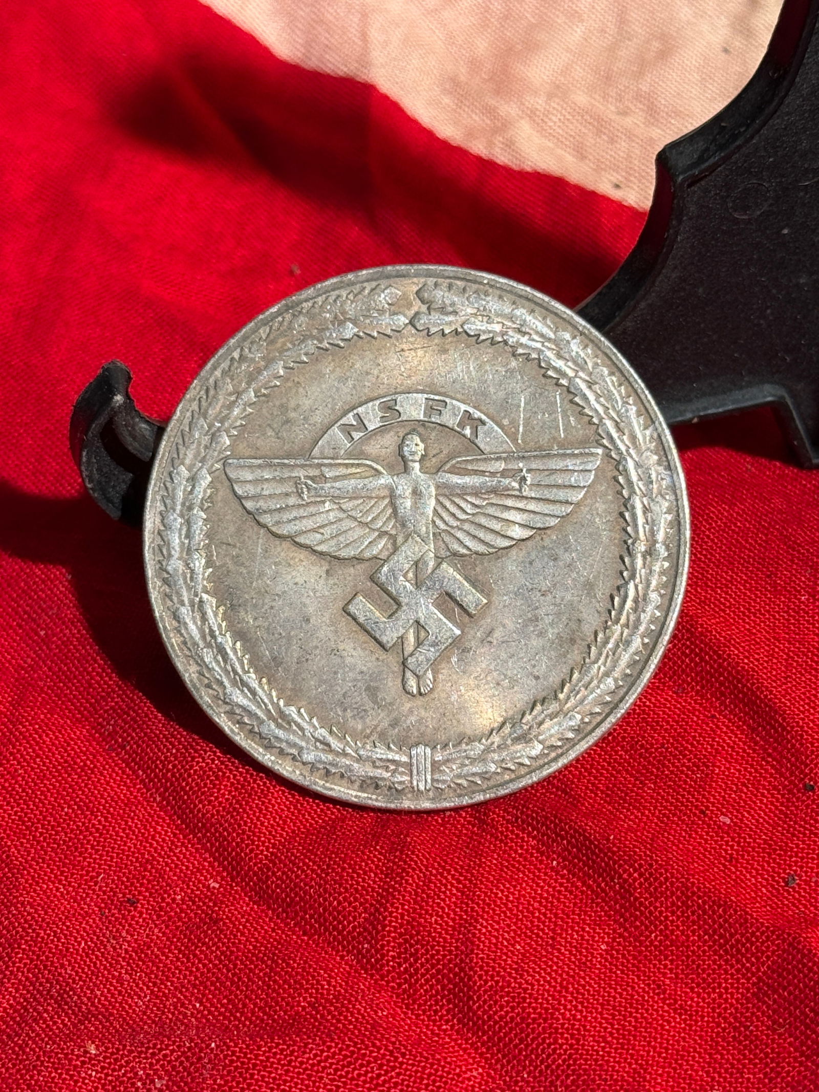 WW2 Hitler Youth Flying Competition Award Plaquette, 1943: Circular metal award medallion issued by the National Socialist Flyers Corps (NSFK) for the 2nd Reich-wide Hitler Youth Glider Competition. The front shows a winged figure above a swastika within a la