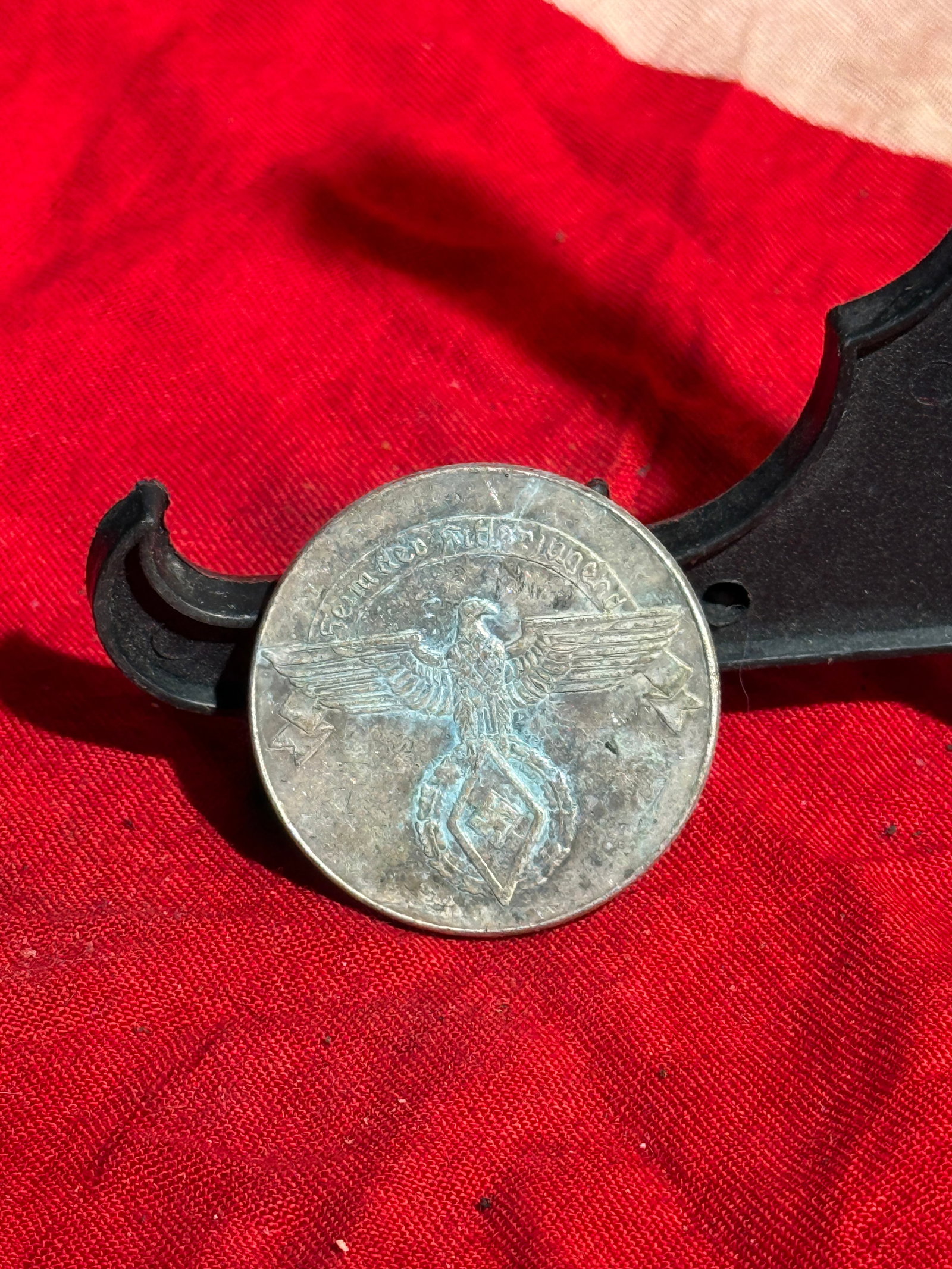 WW2 German Hitler Youth Fundraising Token for Youth Hostel Program: Small German fundraising token associated with the Hitler Youth (Hitlerjugend), likely produced in the 1930s–1940s. The obverse shows a Reich eagle with a swastika emblem and surrounding inscription