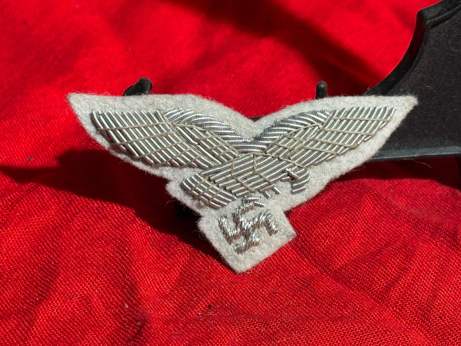 WW2 German Luftwaffe Officer’s Cap Eagle (Hand-Embroidered Bullion Insignia), Nazi Germany, c.: Hand-embroidered Luftwaffe officer’s cap eagle insignia worn on the visor caps of German Air Force officers during the Third Reich period. The emblem depicts the spread-winged Luftwaffe eagle clutch