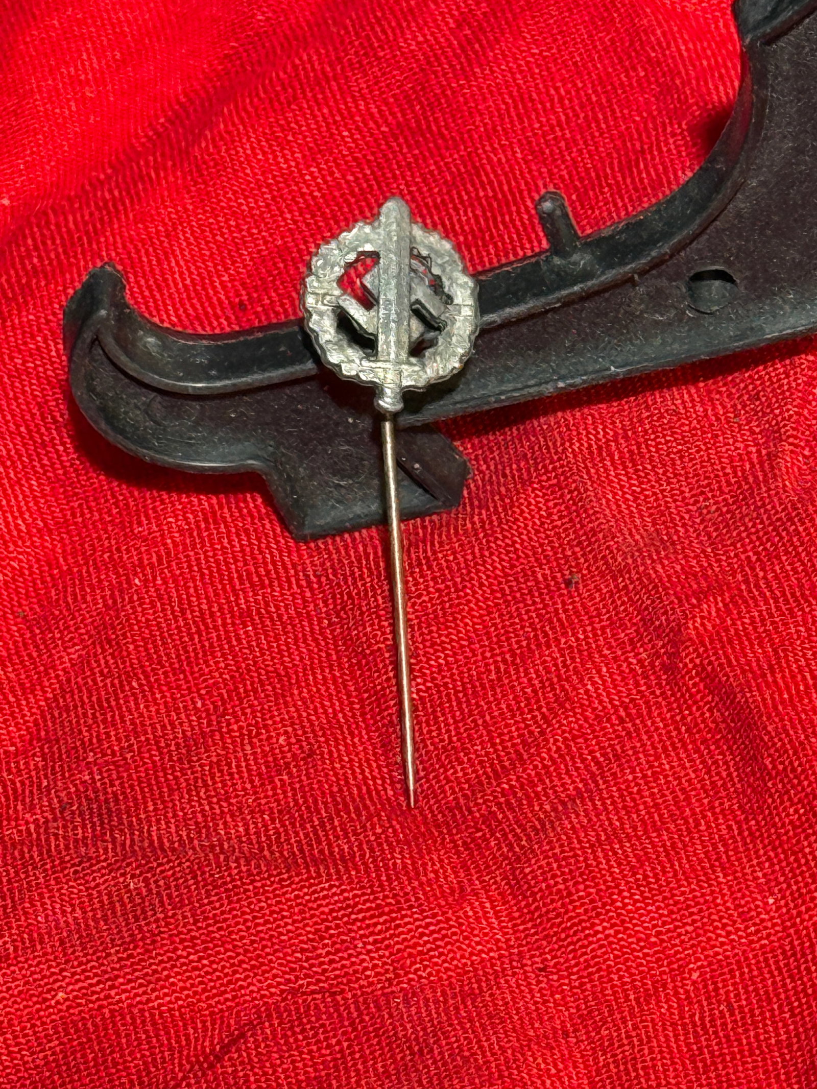WW2 German SA (Sturmabteilung) Membership Stick Pin, Germany, c. 1933–1939: Small metal lapel stick pin bearing the SA monogram—a stylized “S” and “A”—set within an oak-leaf wreath, the traditional German symbol of strength and honor. The emblem represents