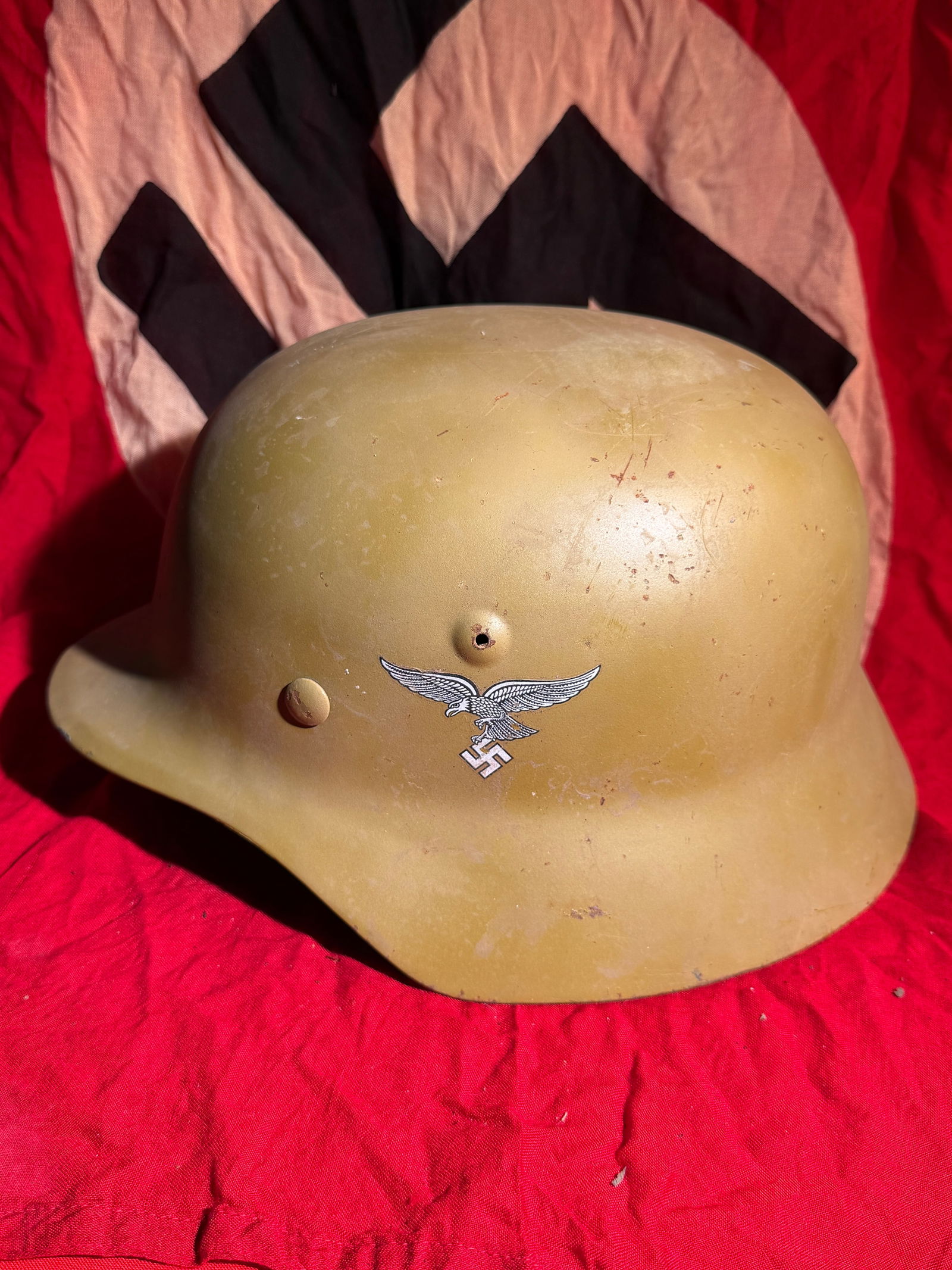 WW2 German Double Decal Luftwaffe M35 Steel Combat Helmet, c. 1935–1945: Steel combat helmet of the German Luftwaffe (air force), model M35, finished in a sand-yellow field repaint likely applied for use in arid or Mediterranean theaters during the Second World War. The le