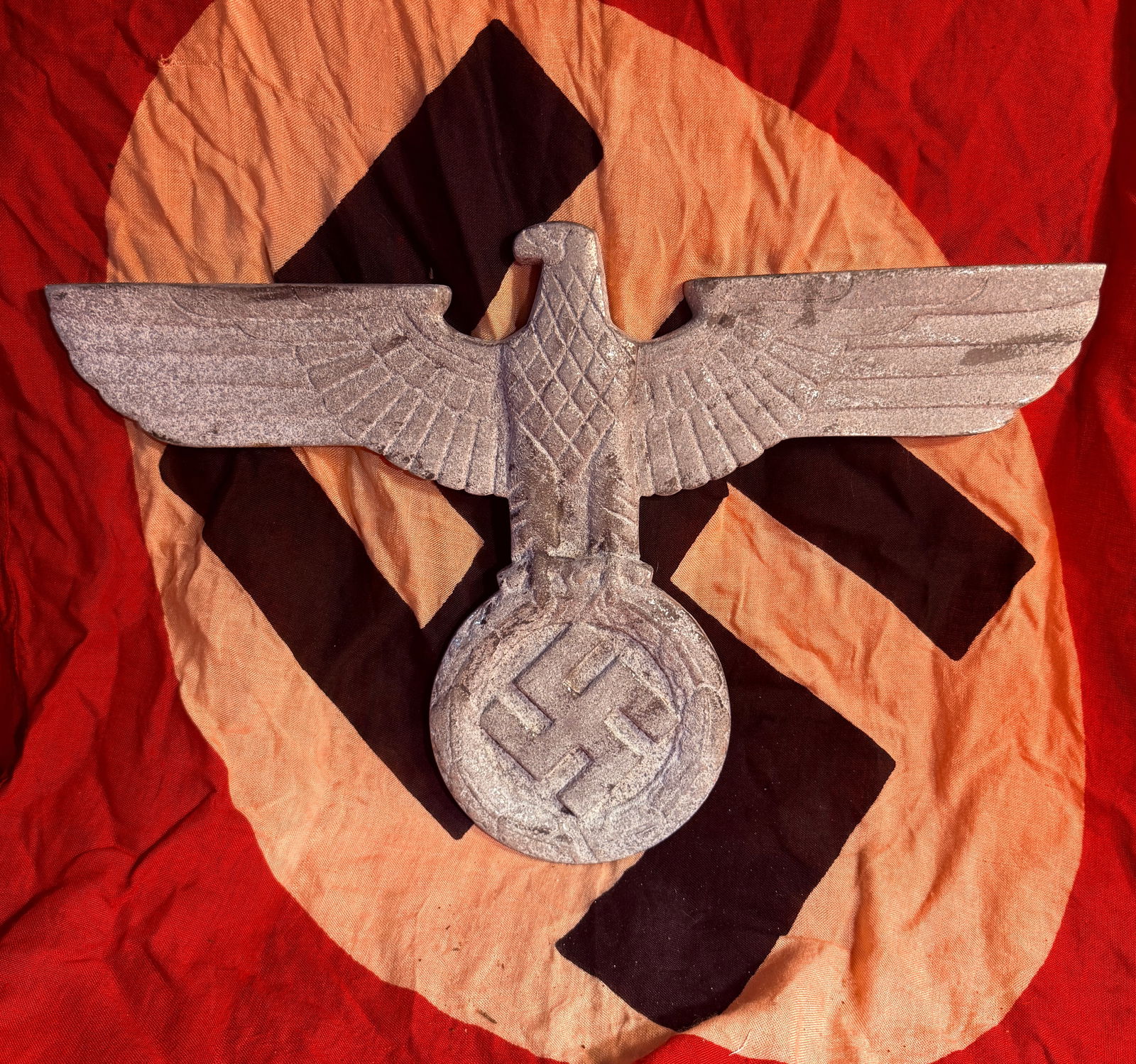 WW2 German Large Third Reich Eagle Emblem (Architectural or Display Plaque), c. 1933–1945 With RZM: Cast metal eagle emblem from the Nazi Germany period, depicting the spread-wing Reich eagle clutching a wreath with a swastika. Measuring roughly over 12 inches across, this oversized piece was likely
