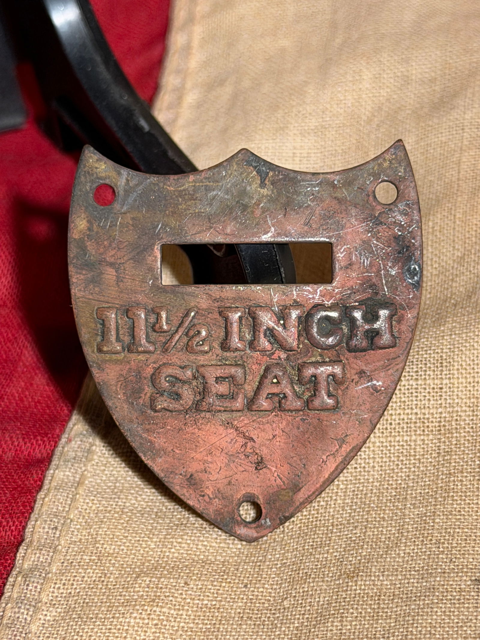 Rare Civil War Saddle Shield Plate Badge: This small cast metal plate marked “11½ INCH SEAT” is a component from Rare Civil War Saddle. The shield-shaped plate features a rectangular opening and three mounting holes used to