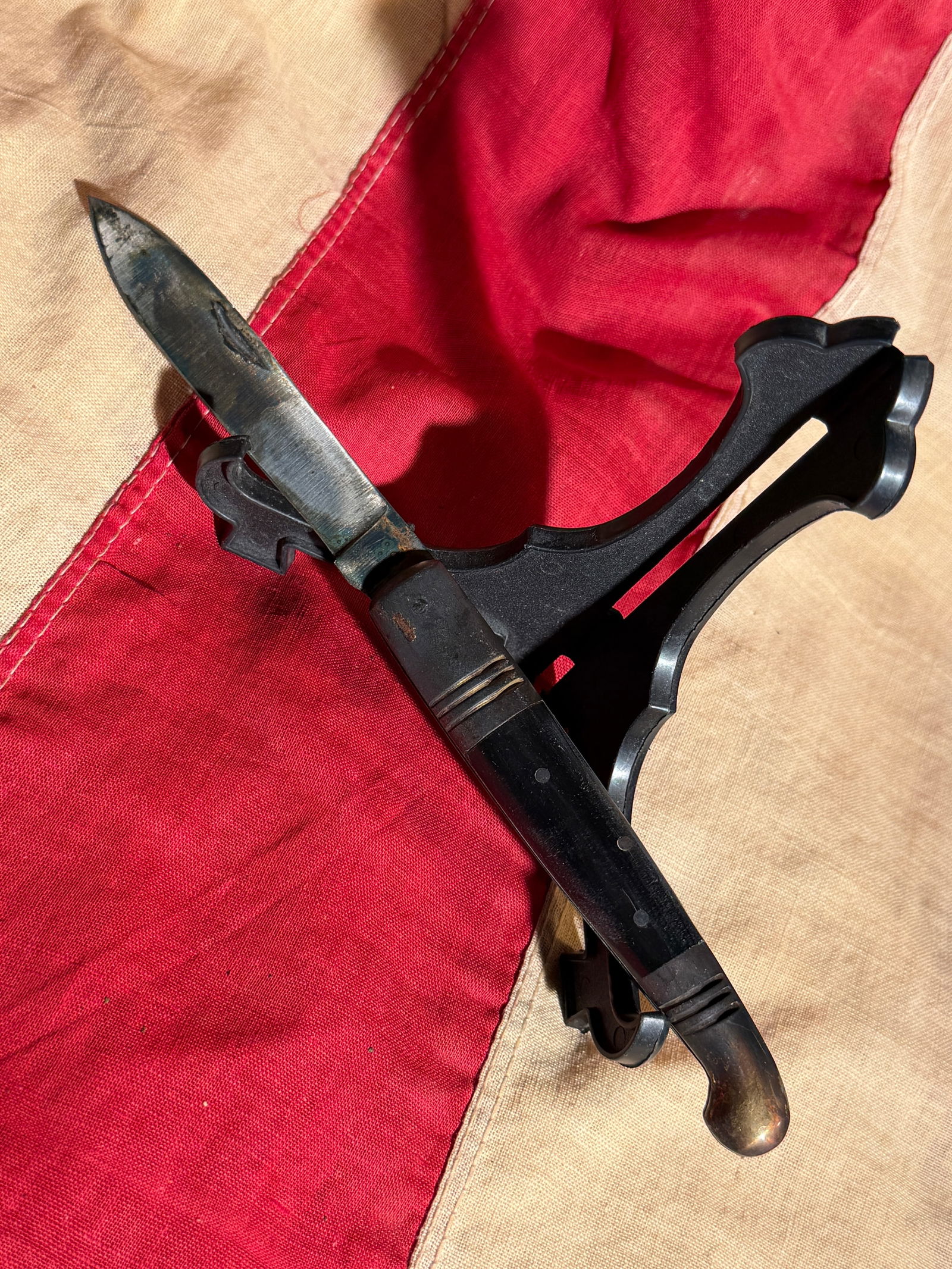 Revolutionary War Officer Soldiers Pocket Knife: This small fixed-blade utility knife, measuring approximately 8 inches in overall length, features a narrow steel blade and a dark handle secured with metal pins and fitted with metal bolster fittings