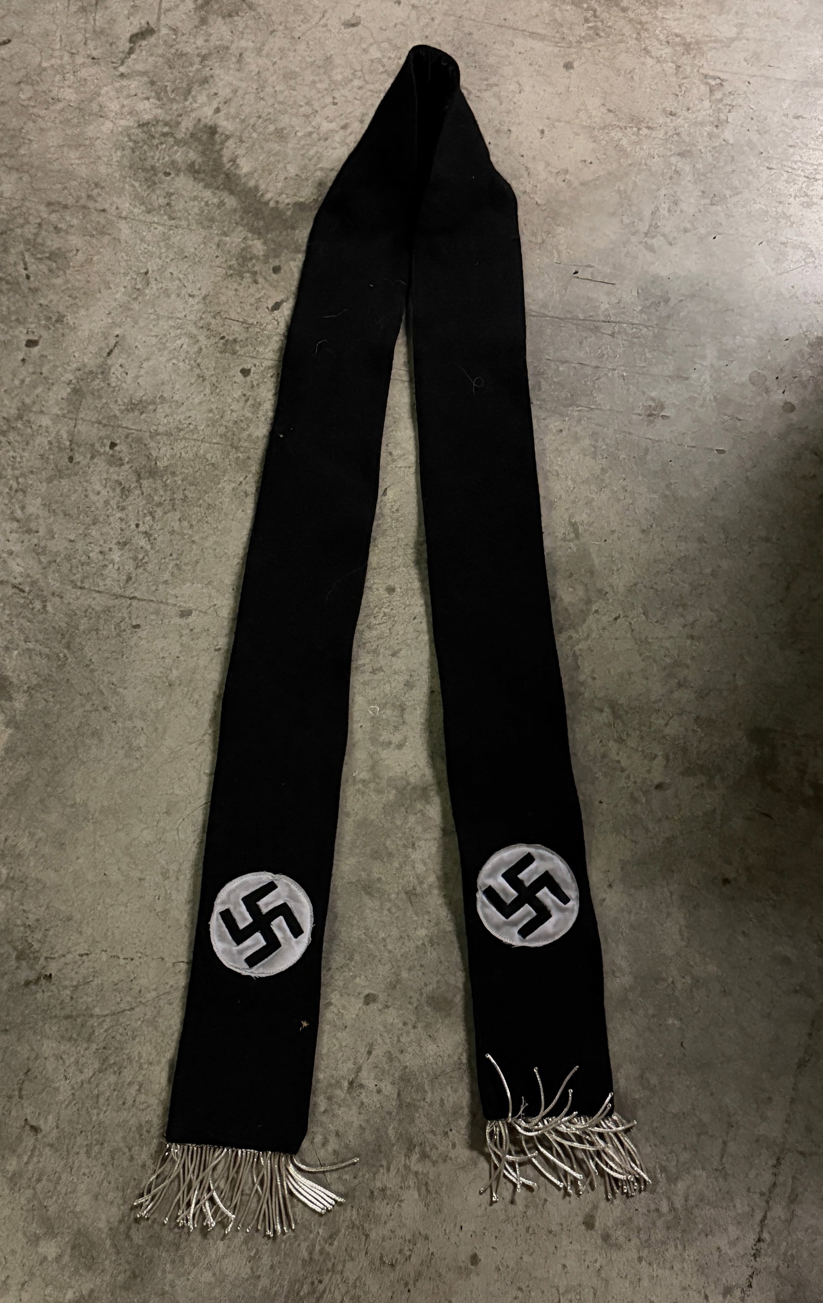 Nazi Party Waffen SS Ceremonial Scarf or Stole – Germany, World War II Era: This long black ceremonial scarf or stole dates to the Nazi period in Germany (1933–1945) and features embroidered circular insignia containing the swastika, the central political symbol used by the