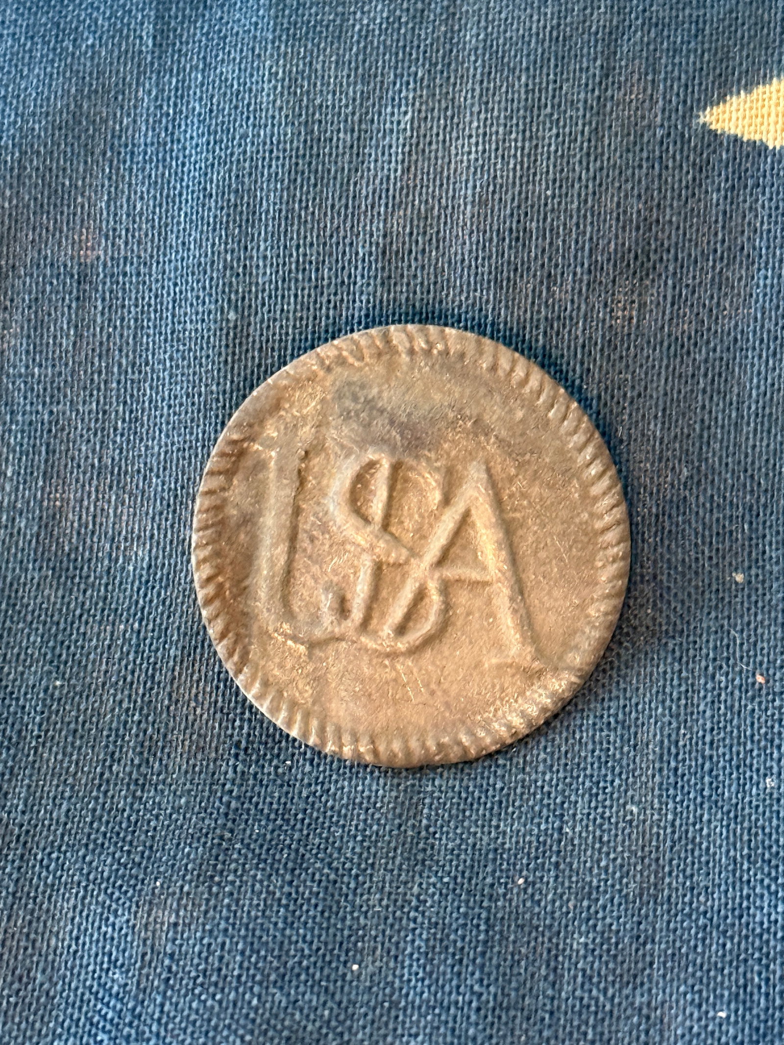 Revolutionary War “USA?? Pewter Uniform Button, c. 1775–1783: American Revolutionary War pewter uniform button bearing the intertwined letters “USA,” a patriotic device symbolizing the newly formed United States of America. This style of button is associ