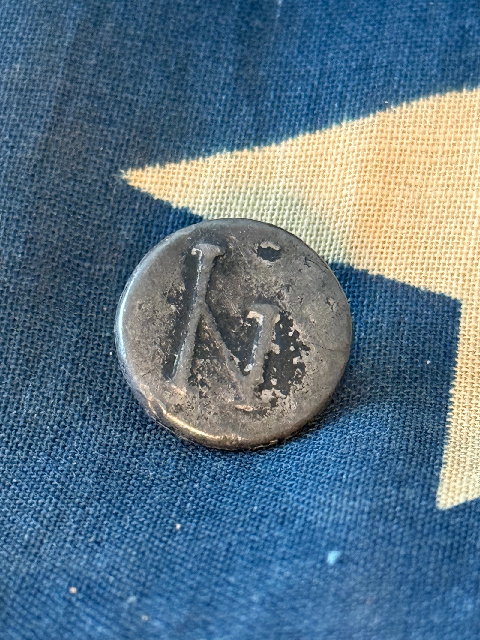 Revolutionary War Continental Army New York Regiment Pewter Button, c. 1775–1783: American Revolutionary War pewter uniform button attributed to a New York Continental Army regiment, featuring a raised “NY” monogram on the face. This simple yet distinctive design reflects e