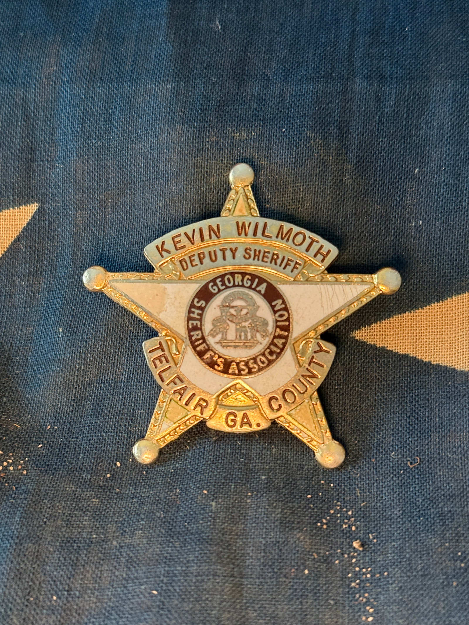 Deputy Sheriff Badge of Kevin Wilmoth, Telfair County, Georgia: Five-point star badge issued to Deputy Sheriff Kevin Wilmoth of Telfair County, Georgia. The badge features the seal of the Georgia Sheriffs’ Association at its center and identifies the wearer’s