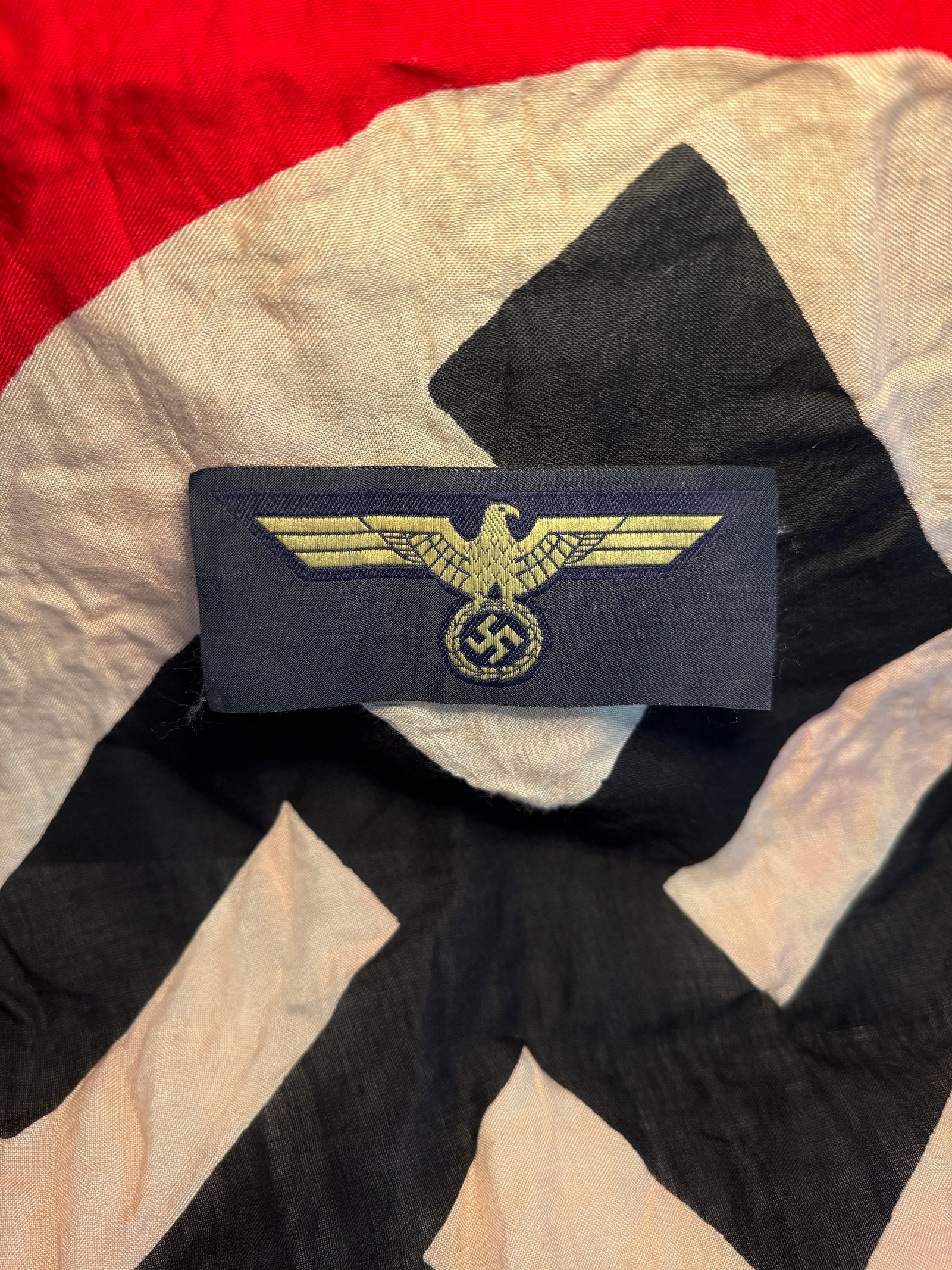 German Luftwaffe Officer’s Breast Eagle (Hoheitsabzeichen), c. 1935–1945: This embroidered cloth insignia is a Luftwaffe officer’s breast eagle, known in German as a Hoheitsabzeichen. The emblem features a stylized eagle with outstretched wings clutching a wreath containi