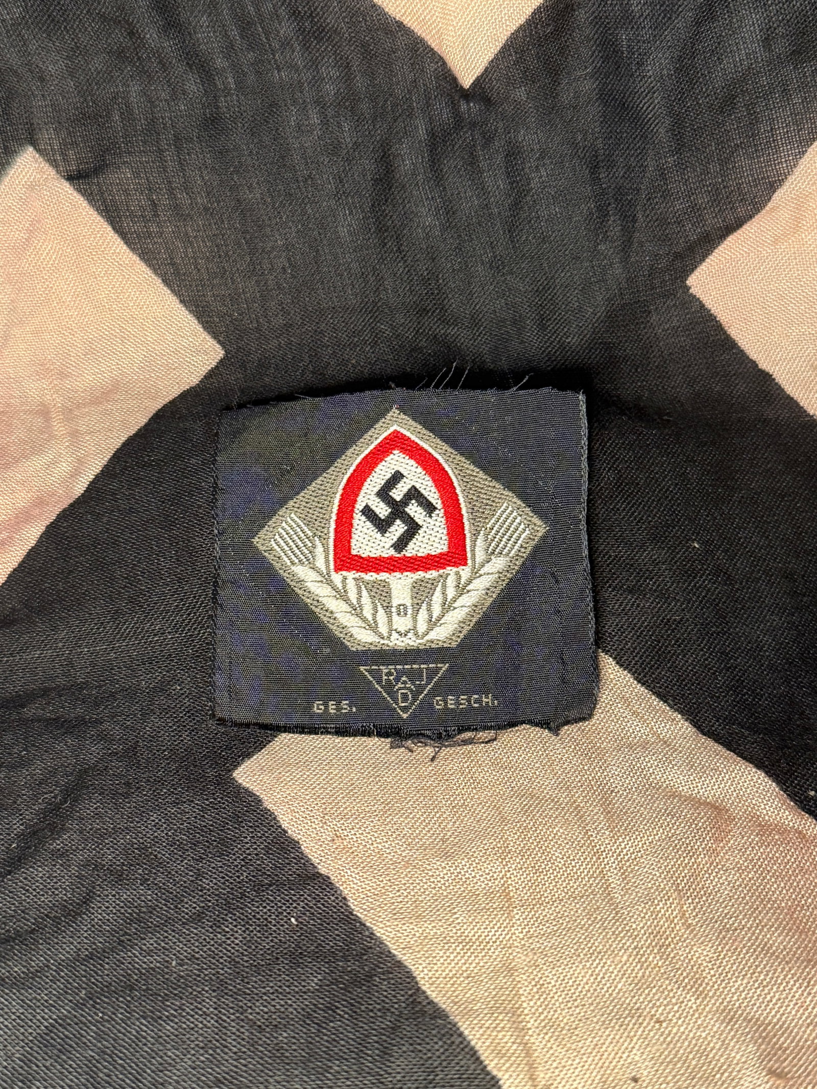 WW2 Reich Labour Service (RAD) Cap Insignia: This embroidered cloth insignia represents the Reich Labour Service (Reichsarbeitsdienst, RAD), a state organization established in Nazi Germany to provide compulsory labor service for young men and l