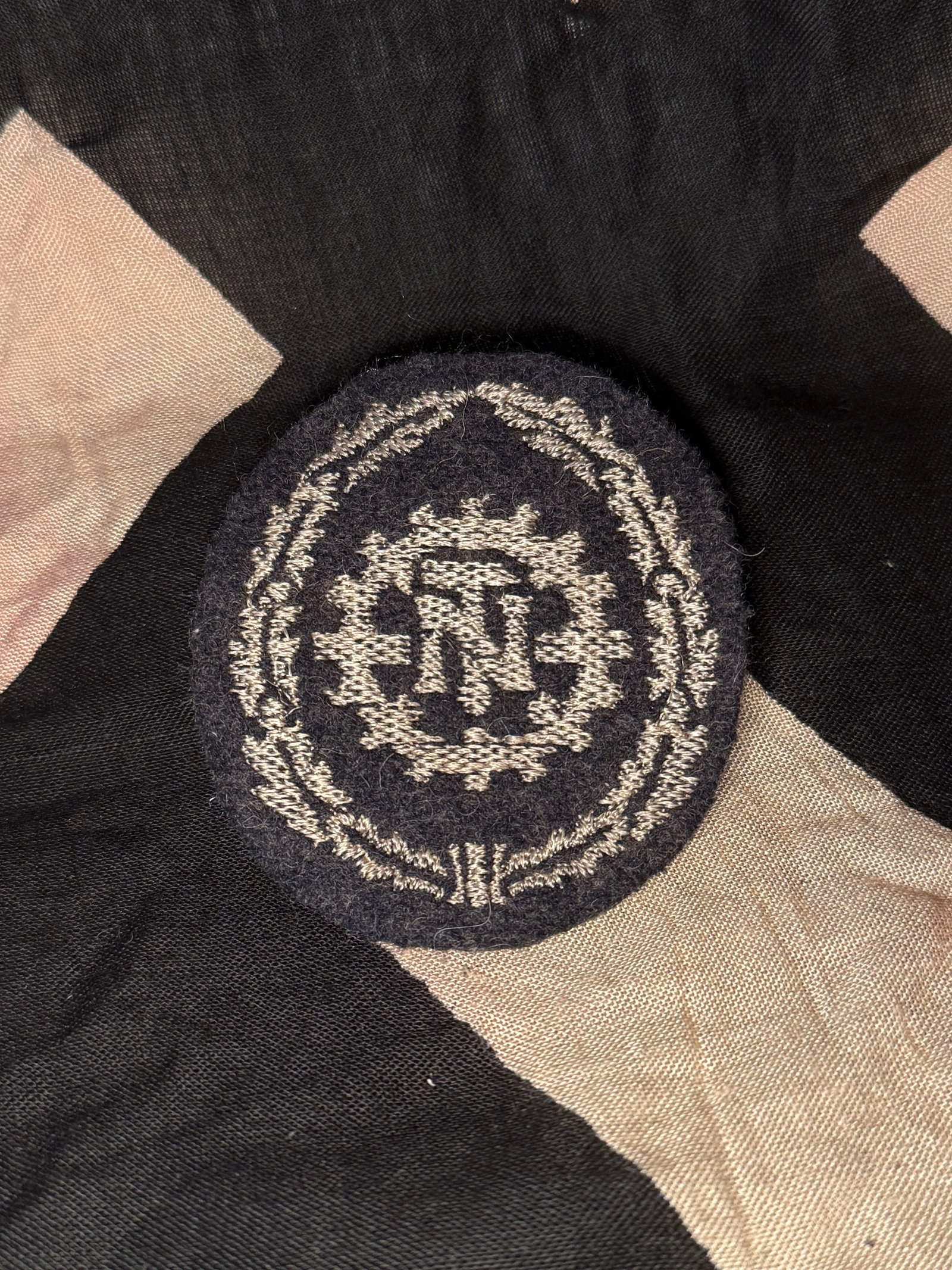 WW2 Technische Nothilfe (TeNo) Sleeve Badge: This embroidered cloth insignia represents the Technische Nothilfe (Technical Emergency Corps), commonly abbreviated TeNo, a German technical service organization active during the Nazi period. The em