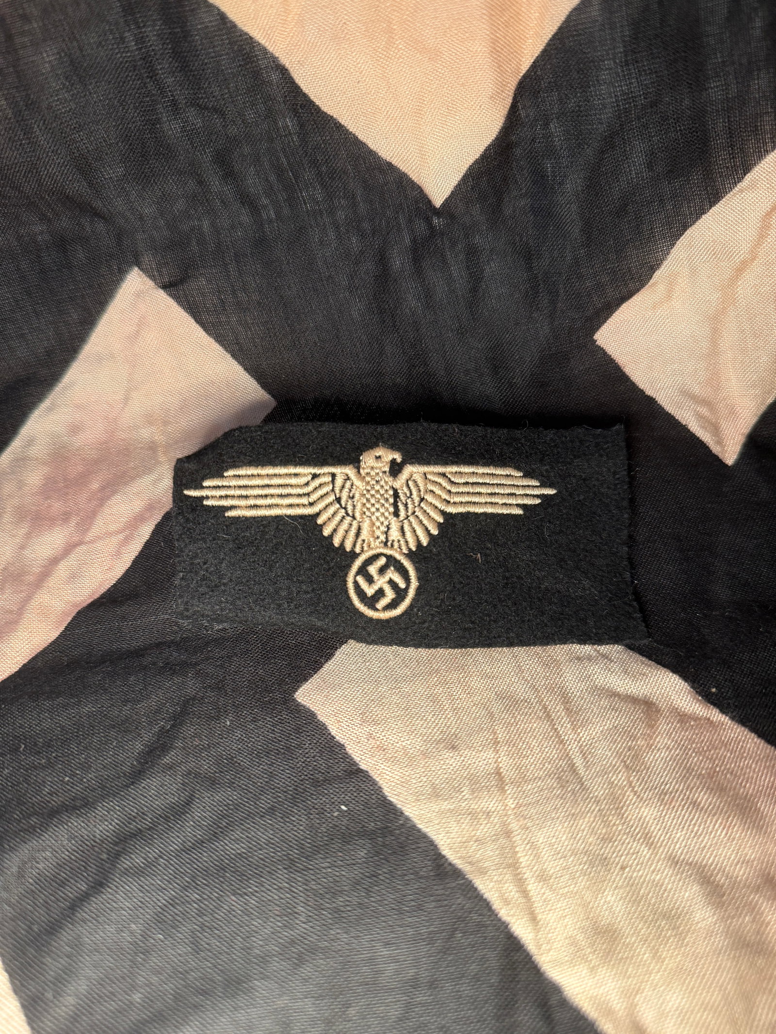 WW2 German Waffen SS Police Cap Eagle Insignia (Ordnungspolizei): This embroidered cloth insignia represents the cap eagle worn by members of the Ordnungspolizei (Order Police) in Nazi Germany during the Second World War. The design features a spread-wing eagle posi